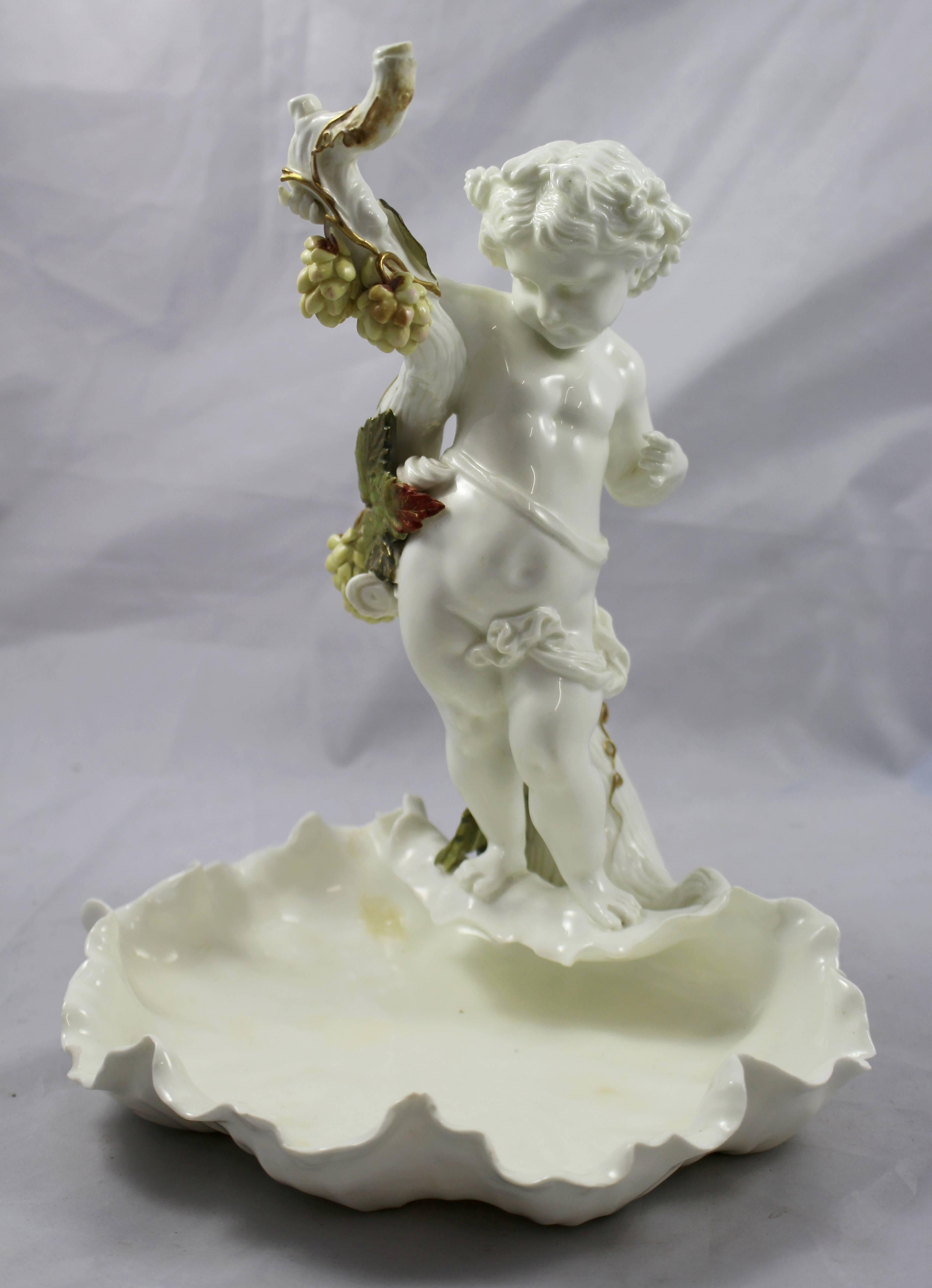 Manufacturer Moore Brothers.
Composition Porcelain.
Measures: Height 25 cm / 10 in.
Backstamp stamped Moore Bros in red with registration number.
Condition good condition. Three nibbles to the dish border. Small damage to a finger on each hand.