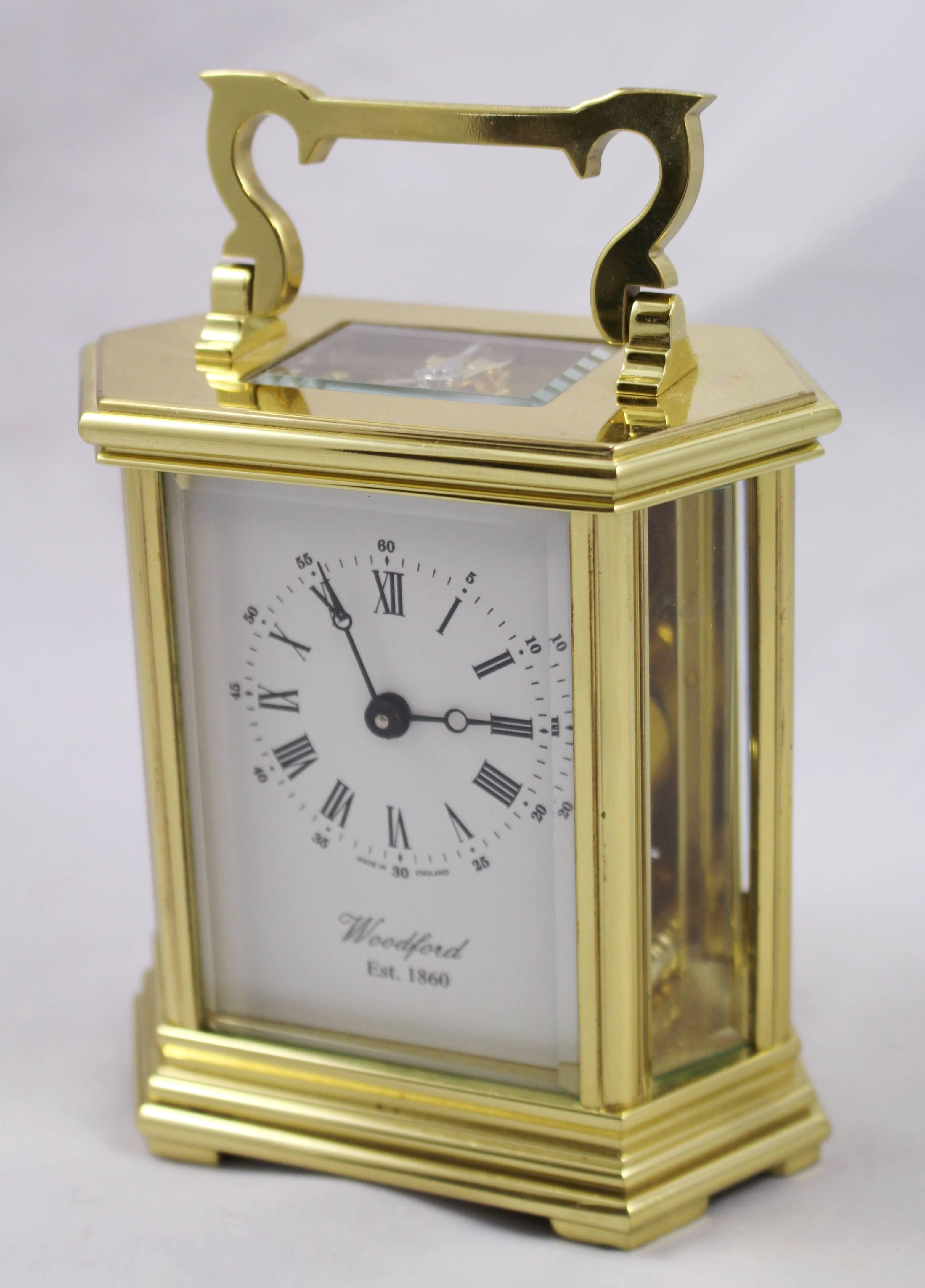 

Maker Woodford, made in England.
Height (handle up) 15 cm/6 in.
Movement fully working eight day mechanical movement.
Face white enamel dial with Roman numerals and Arabic seconds. Blued steel hands. 'Made in England.' 'Woodford