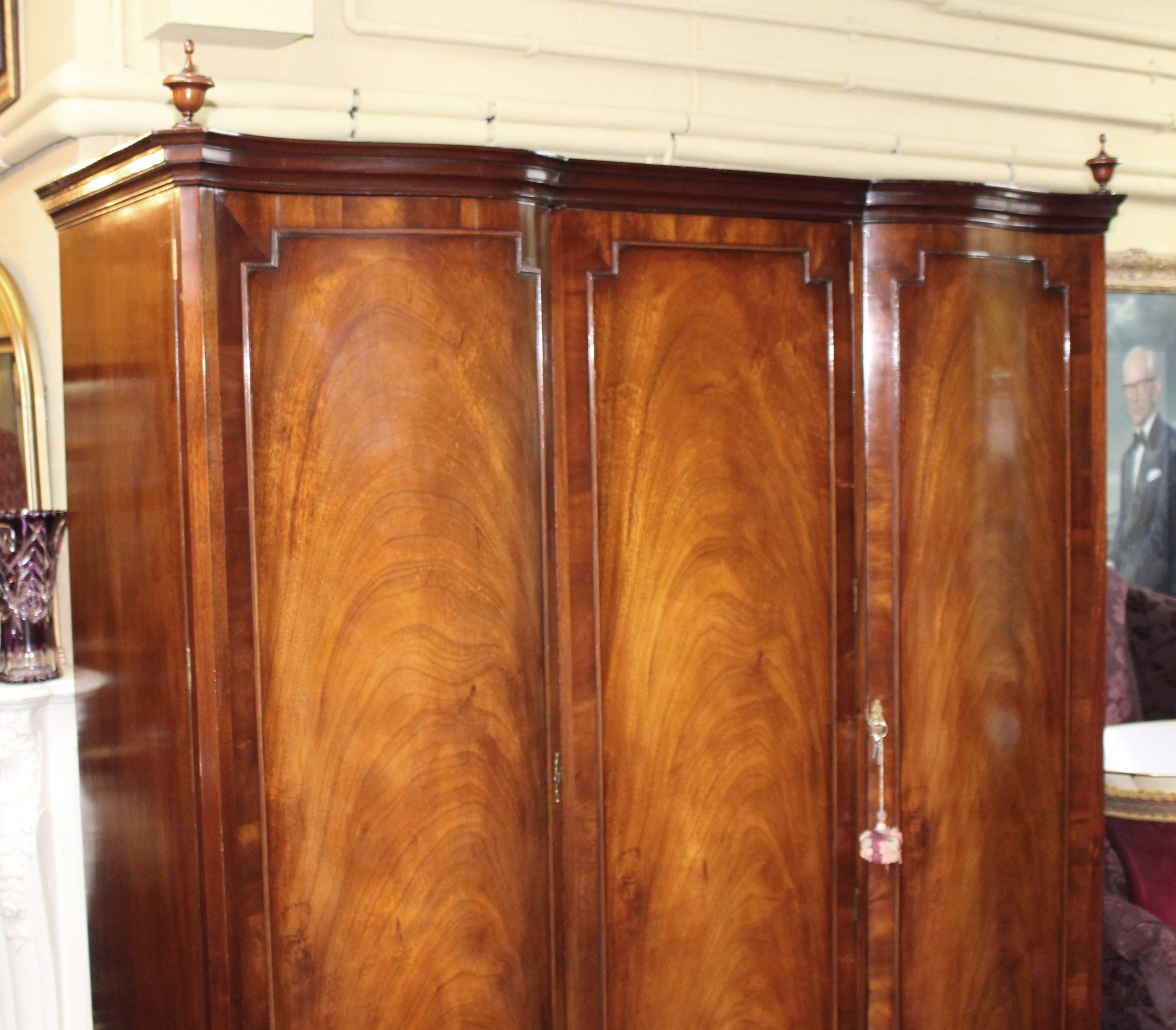 
Width	183 cm	6 ft
Depth	65 cm	25 1/2 in
Height	210 cm	6 ft 10 1/2 in



Period	Mid 20th c.
Wood	Flame mahogany
Condition	Good condition commensurate with age. One or two minor marks to finish, some age related wear. Keys present for