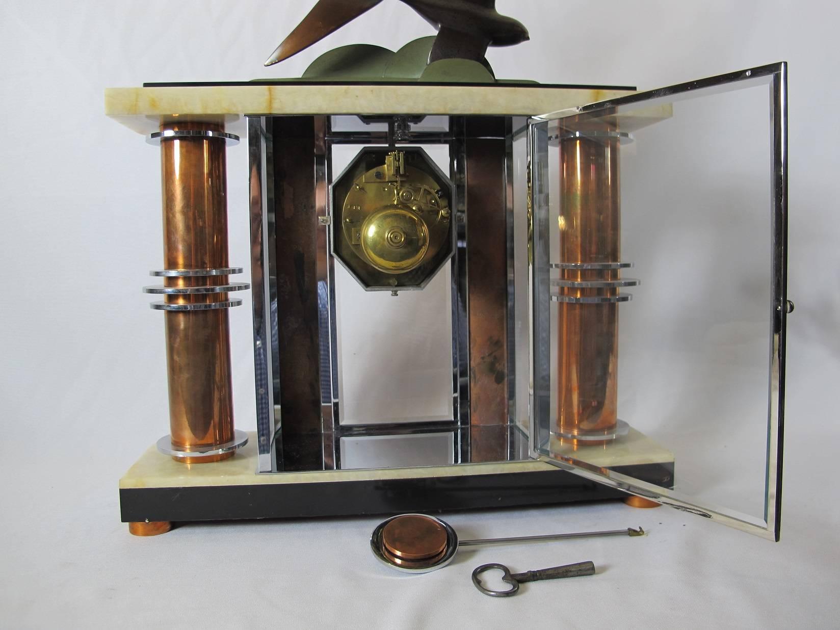 Mantel clock of the Art Deco period, circa 1925. Made of marble, bronze and copper. Restored, including clock key.