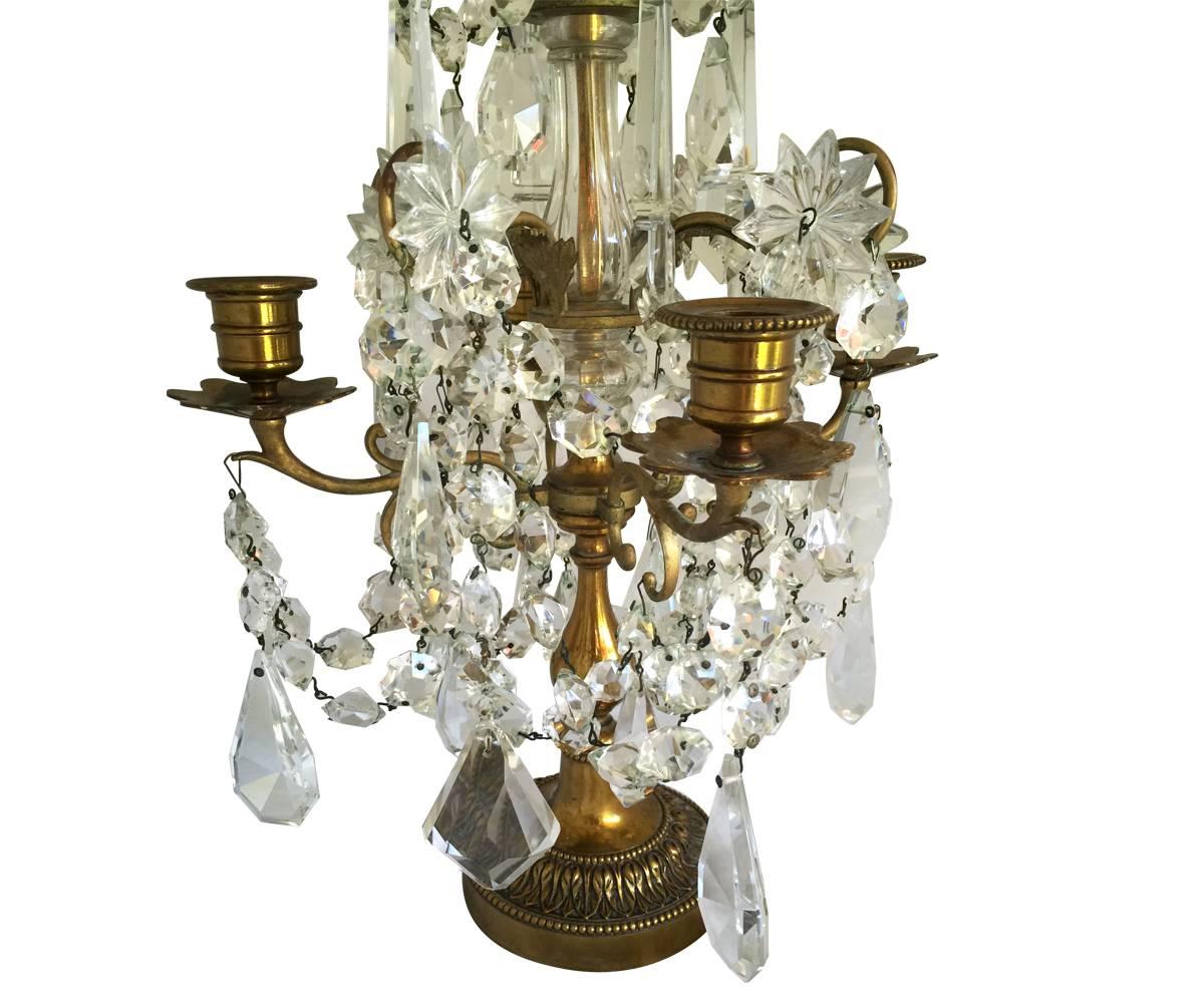 This pair of candelabra date to the 1920s and exudes class and style. The crystal is hand-cut with brass stands. These are a great addition to any table.