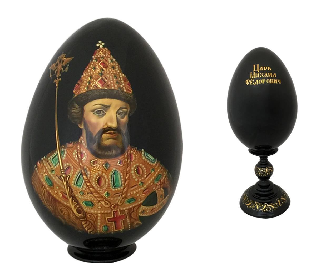 The tradition of giving Faberge eggs began in 1884 when the czar gave his wife an egg fabricated by Faberge with a secret treasure inside. In that tradition these finely painted eggs and stands are made out of one block of wood and then lacquered