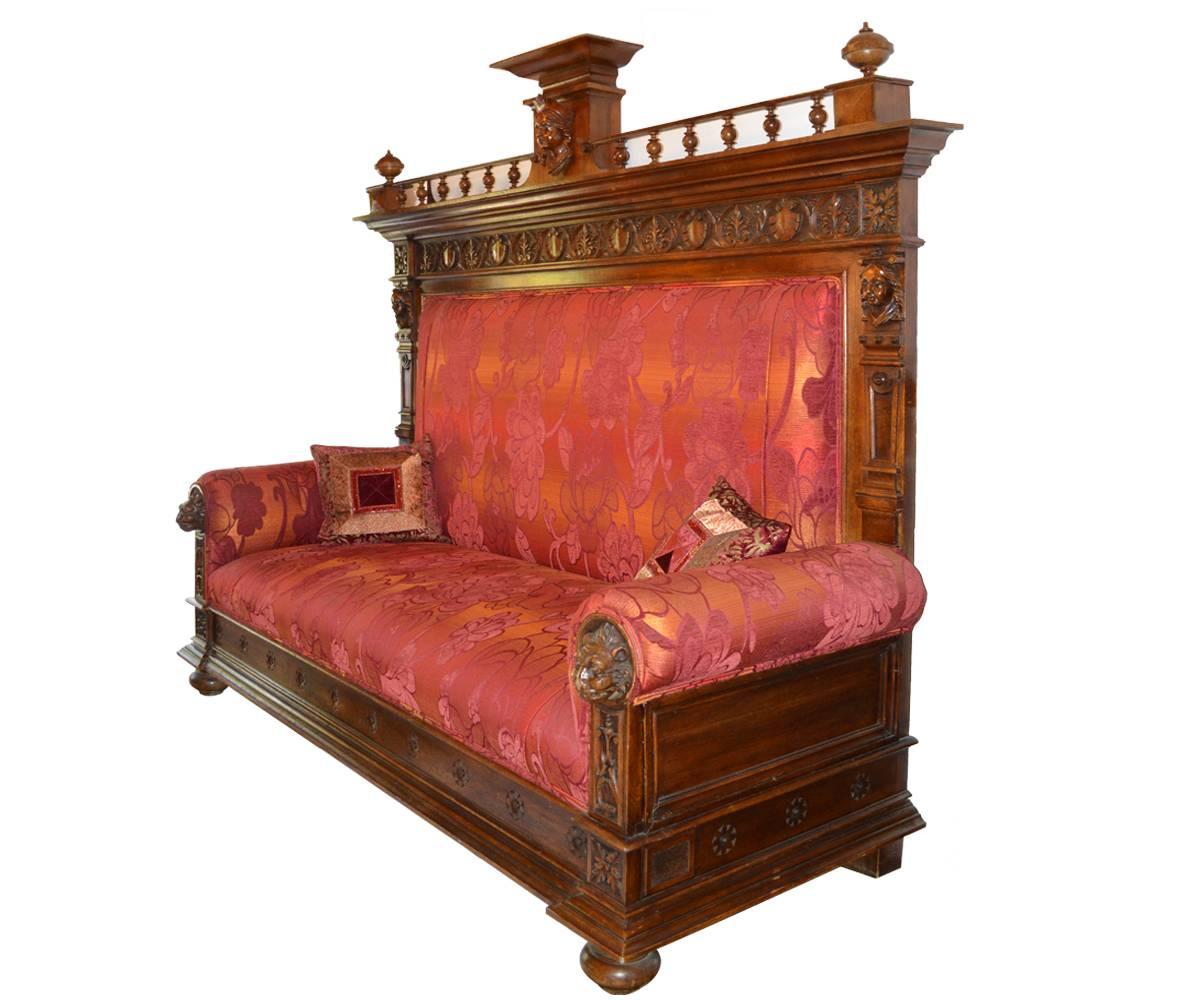 This impressive banquet oak bench has fine French carvings in the popular Gothic style and has been completely refurbished and has new upholstery and two matching side pillows. It is a very flexible piece as it can be used as an individual bench or