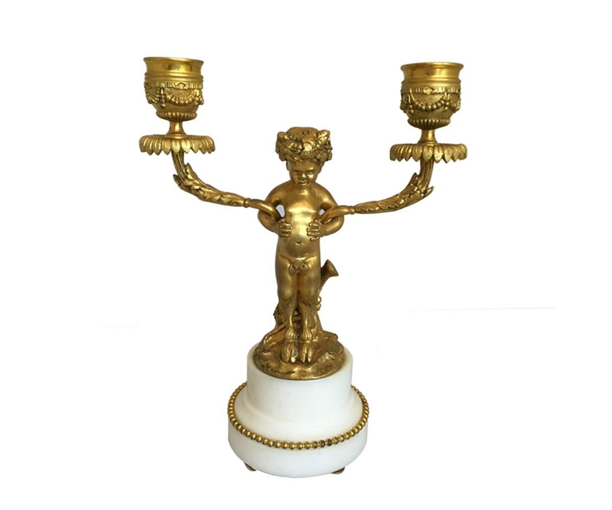 This pair of candelabra is highly unusual as they feature a faun/satyr like creature as the center stem. These mythical beings originated in Greek mythology and later were found in roman culture also. They have two arms and display great casting and