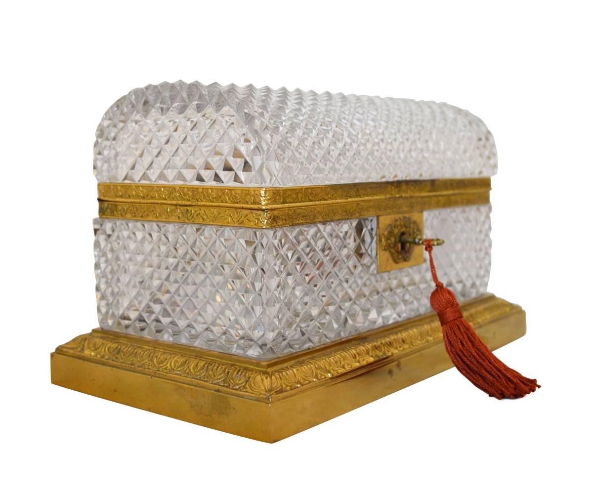 Baccarat hand-cut crystal box with gold-plated brass trimming and includes a key.
