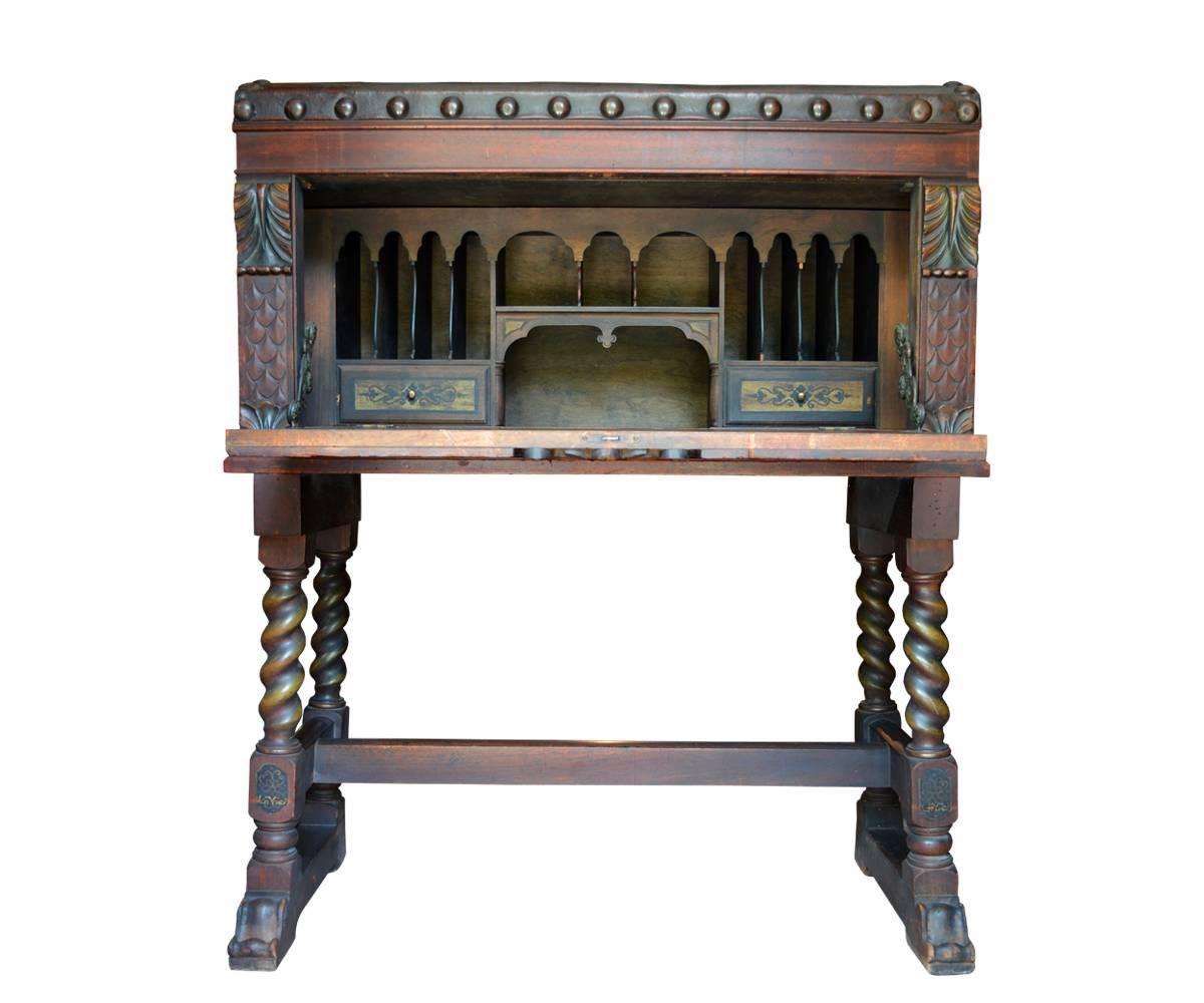 This magnificent secretary has a hand-painted leather top, hand-painted front panels and a hand-painted family crest all remarkably well preserved for its age. The interior features two drawers and twelve separate niches. The piece is it is