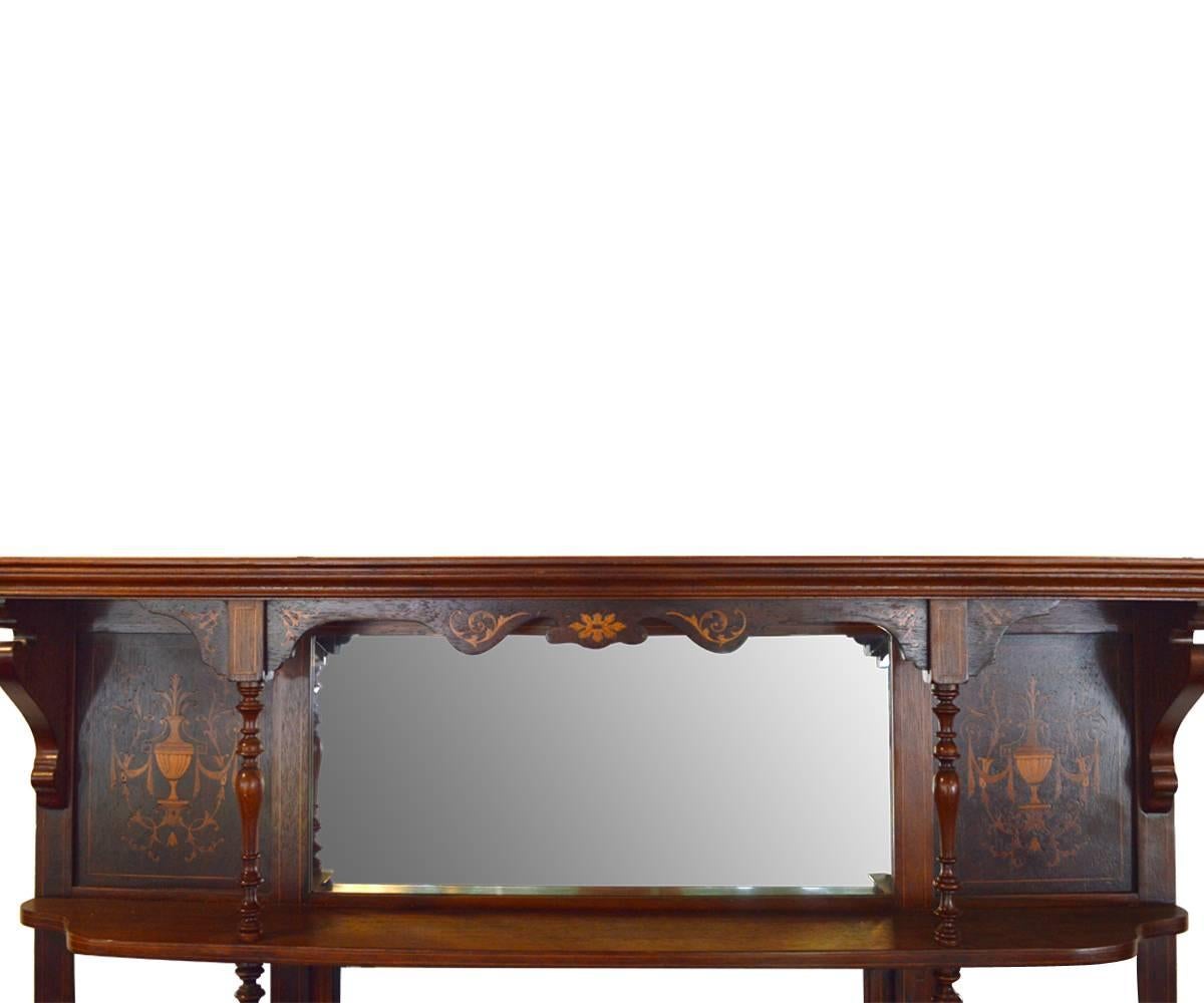 Antique 19th century rosewood and inlaid overmantel mirror with four small shelves and one large. The mantel has beautiful inlaid urns and flowers on top section.
