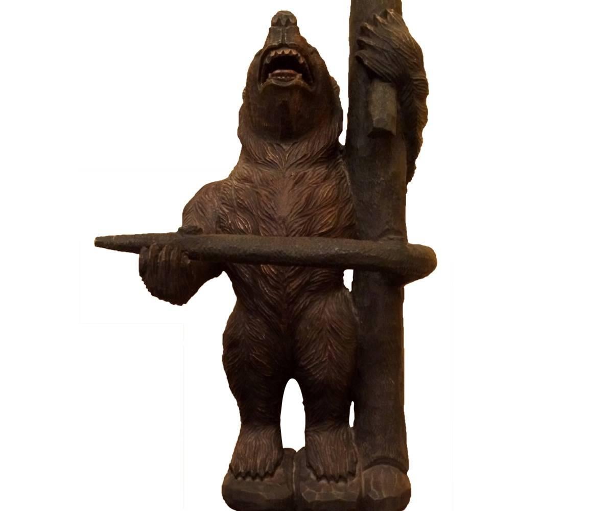 Offered is this delightful Black Forest carved hall stand featuring a mother bear
with her two cubs happily playing in the branches above her. This piece serves as both a coat and hat rack as well as an umbrella stand.