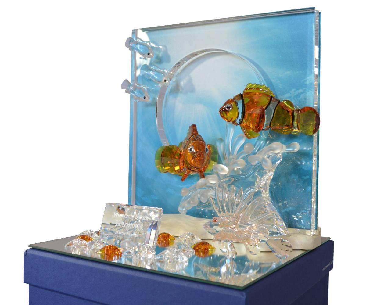 Wonderful Swarovski crystal display featuring both clear and amber glass. This particular piece has multiple starfish and accompanying plaque. Unusually, yhisitem is equipped with a light to enhance the viewing experience.