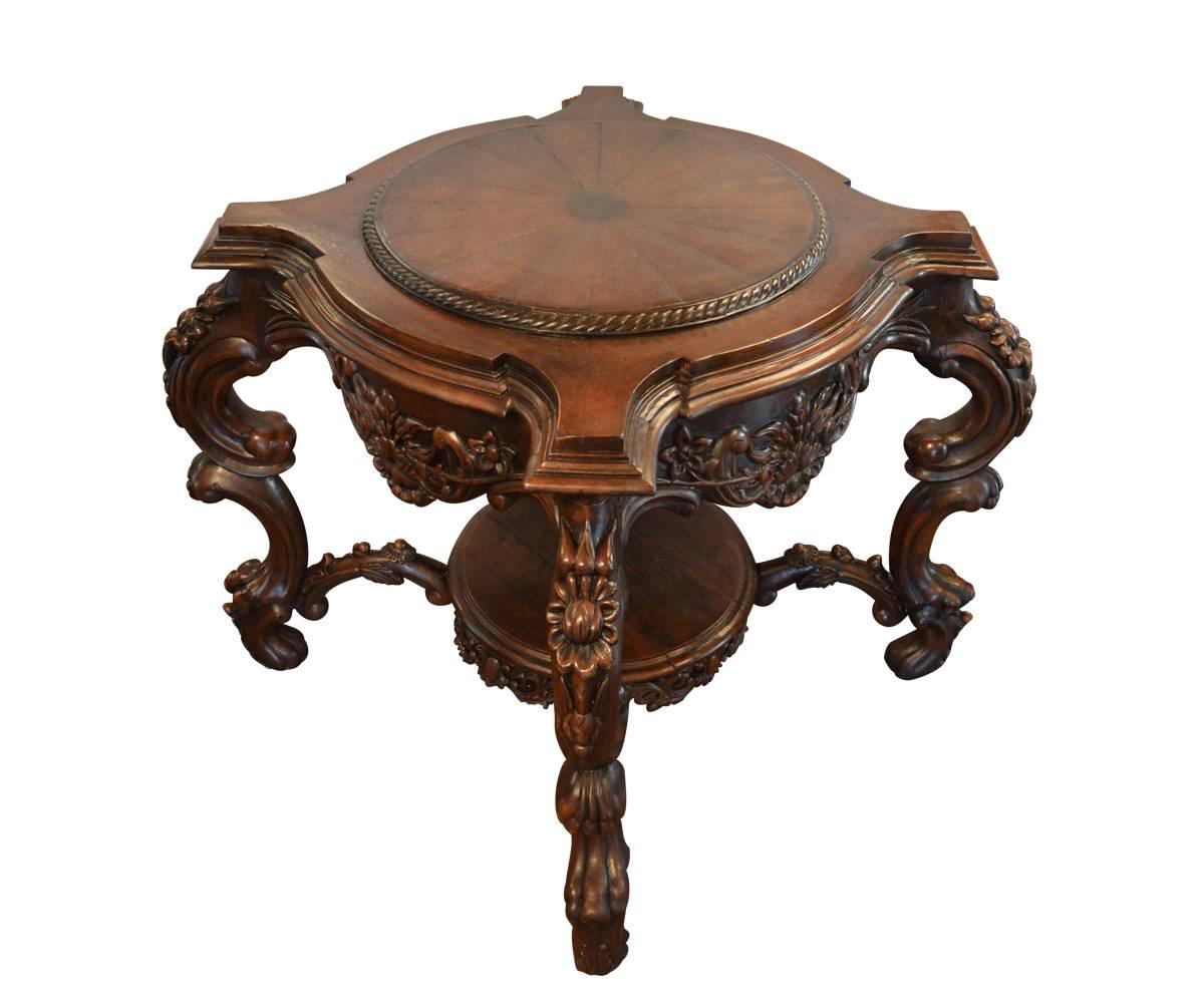 This fabulous colonial tables has a circulate top with four corner supporting carved lion legs and accented by an extensively carved apron and is supported by second round shelf in bottom. These tables have been fully refinished by our experienced