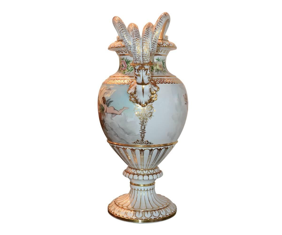 Offered is a magnificent quality antique hand-painted Meissen vase which features gorgeously hand-painted flowers, angels in clouds with putties on soft blue colors. The vase's upper part is also hand-painted flowers around the neck with a pair of
