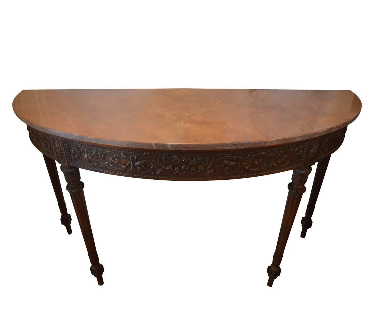 Offered is this exclusive 19th century French Louis XVI style marble-top console which is made from hand-carved walnut. Finishing this piece is a wonderfully matched rust colored marble-top.