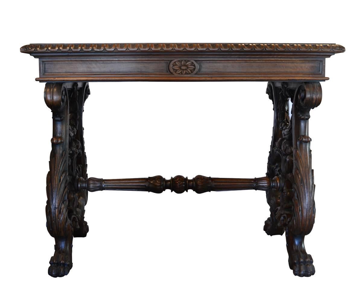 Offered is a beautifully hand-carved, 19th century Italian small table or writing desk in walnut wood. It features acanthus leaves motif with proud lions feet, Please notice that this table, unlike so many other tables, is double carved on both the