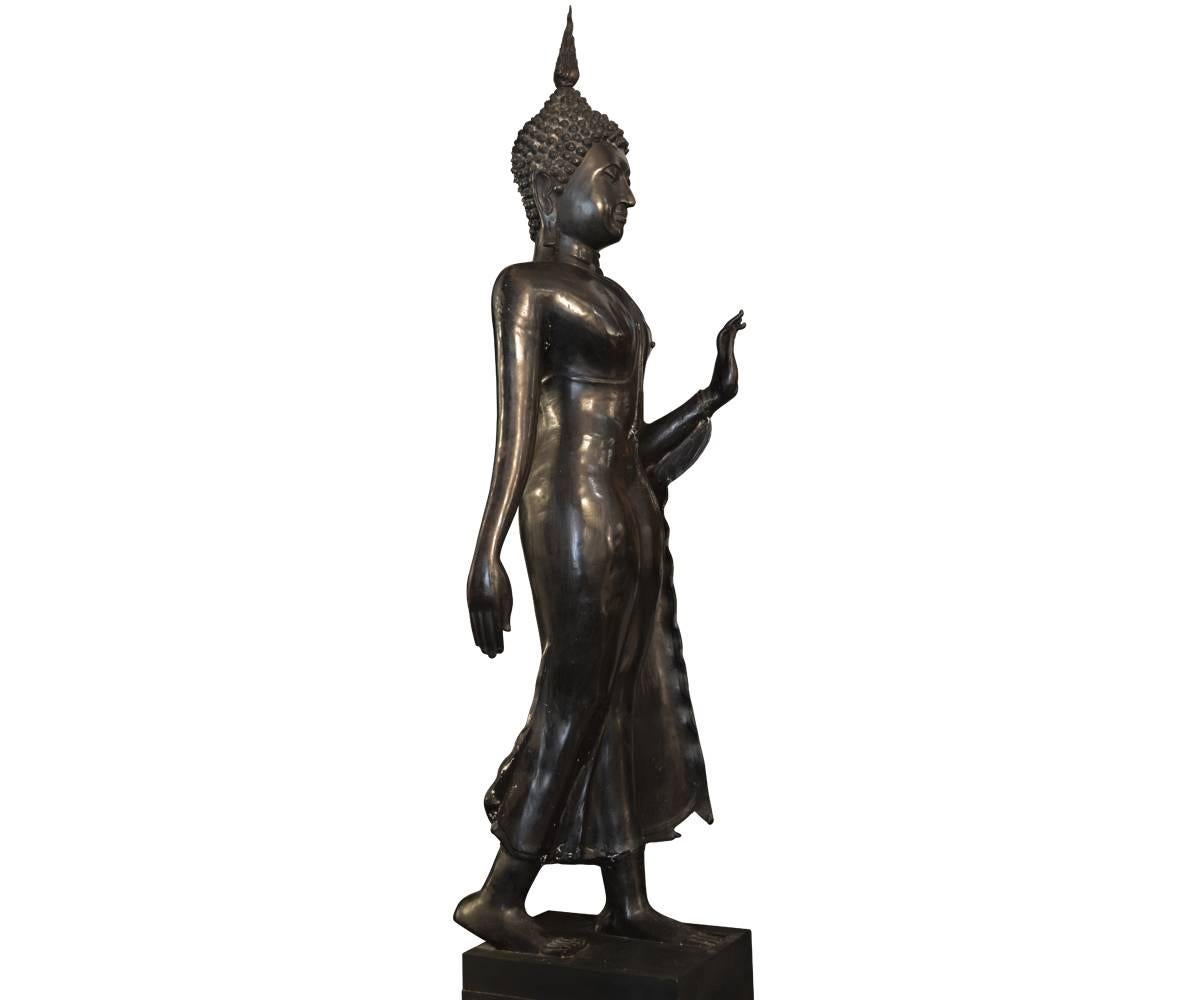 This large Thai bronze Buddha figure is in the Mudra #1 hand position representing no fear. It rest on a wooden base. There is a complementary piece also listed if a pair is desired.

 