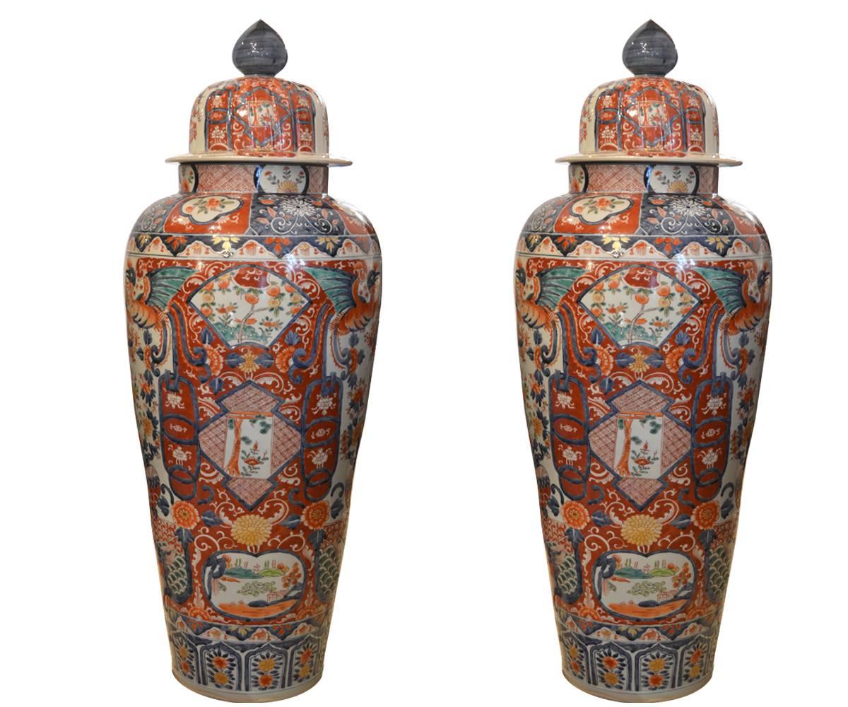 These Japanese Imari hand-painted vases are decorated with Phoenixes and flowers in bright, vibrant colors. At taller than 40 inches, they can be displayed on the floor, small stands or a table.