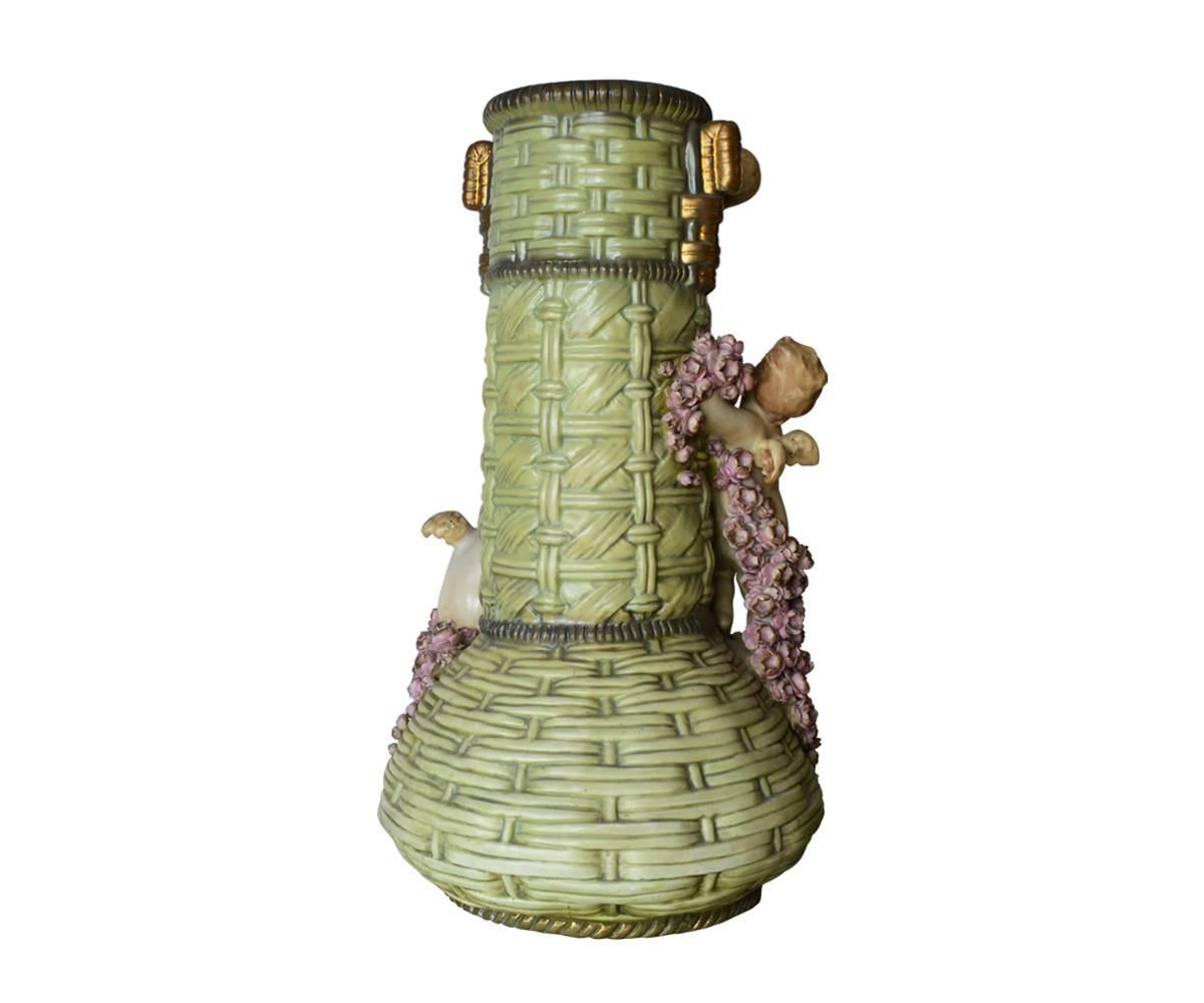 This large vase is in absolutely perfect condition and the quality of the hand painting is just incredible. There are infinite details in this piece with small flowers and three cherubs or putti adorning the stem and top. It has two small gold