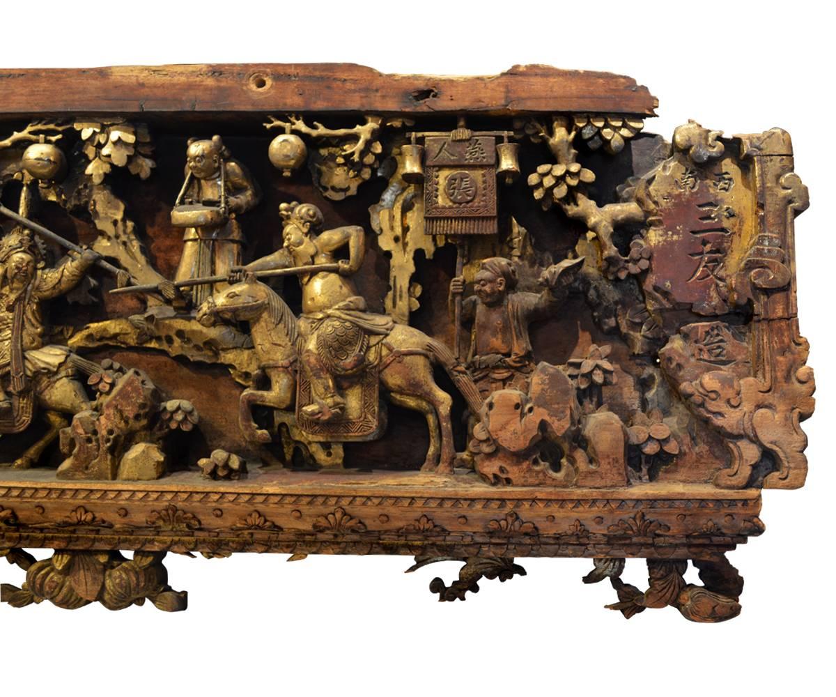 Offered is a large, deeply carved 18th century Chinese lacquered and gilt panel. This panel is unusual in both the size and quality of the carvings. The scene features, among other things, warriors, roosters and much foliage. In person, this is one