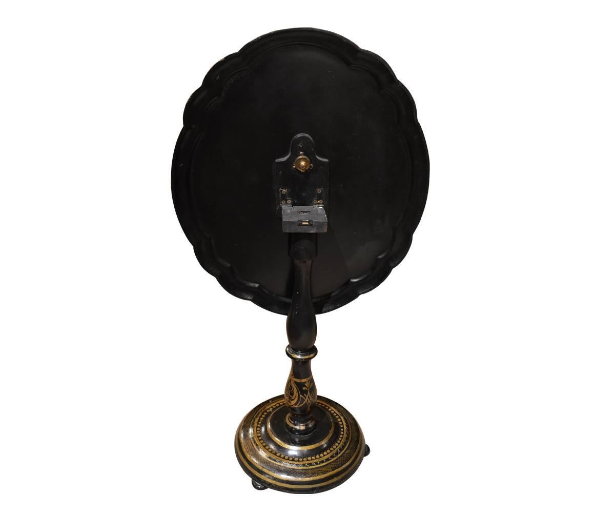 This hand-painted papier mâché tilt top table has mother-of-pearl inlay. This is a fine example of this type of table.