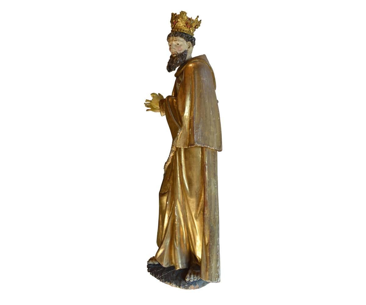 This large Santo is a Spanish Colonial piece from the 18th century in the early Americas. This Saint statue comes from a Spanish church somewhere in the colonial Americas, possibly Brazil. The quality of workmanship, the size of the piece and the