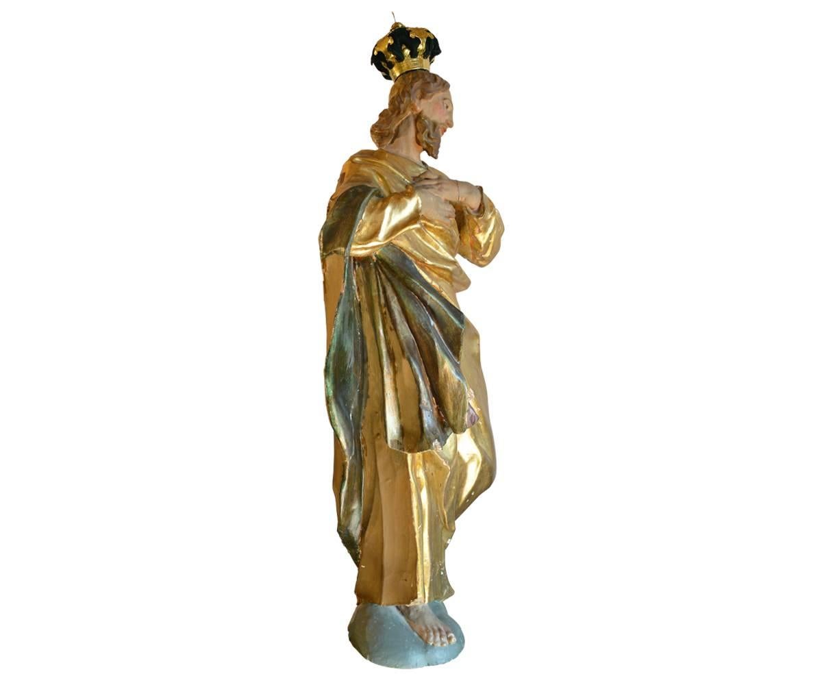 This Santos is absolutely spectacular in all aspects. The crowned figure is covered in polychrome and gilt. The carved wood and gesso piece has the most magnificent flowing robes. The features on the face are so life like and full of emotion. The