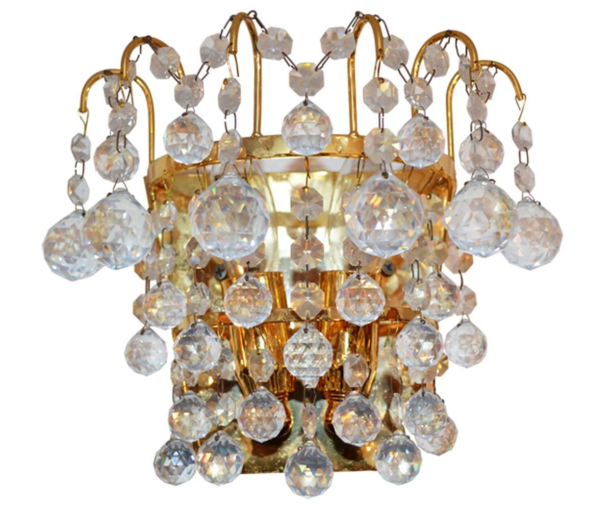This attractive pair of Mid-Century of brass wall light sconces have very good round cut Austrian crystal.