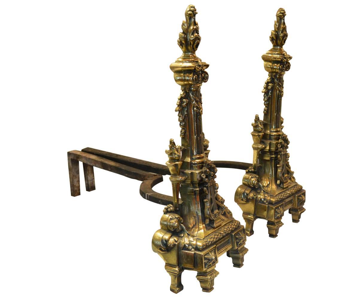 Offered are these well detailed Louis XVI style fireplace andirons. These are decorated with, among other things the sought after flame and harp. Please refer to the pictures.
     