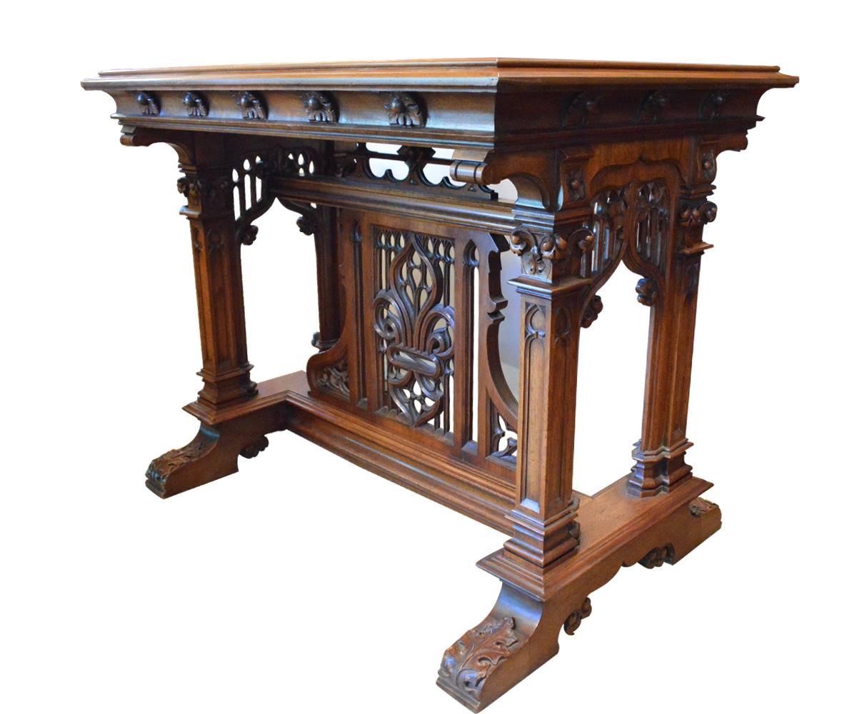 This Gothic style table is unique in design and has open work in the middle of the stretcher with superb hand carvings of the highest quality.