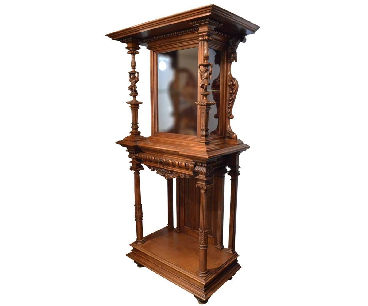 Offered is the superbly hand-carved and detailed French display cabinet on a stand in a smaller size making quite versatile. The ever favourite jesters decorate the spindles framing the cabinet which has the original red velvet inside.