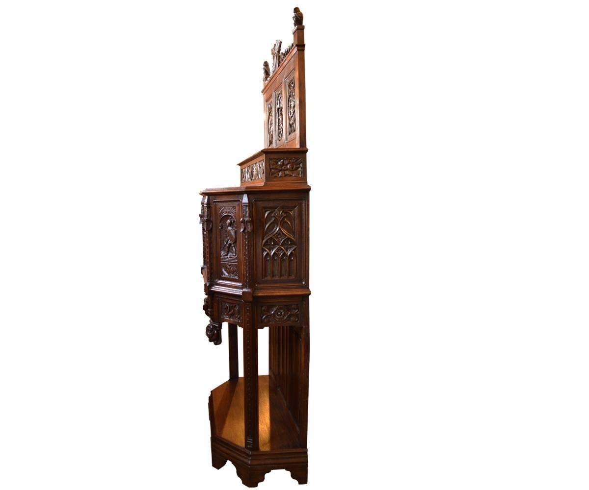 This incredible Gothic Revival cabinet has so much carving it takes some time to digest. You will find a King and Queen, dragons, coat of arms with a crown, knights, soldier on horseback and we could continue. Look at the pictures to be amazed by