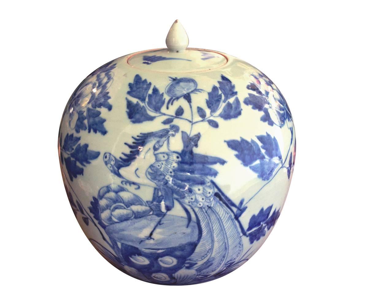 This is an antique matching pair of Chinese hand-painted jars with lids. The cobalt blue painted scene includes Phoenix birds and flowers.