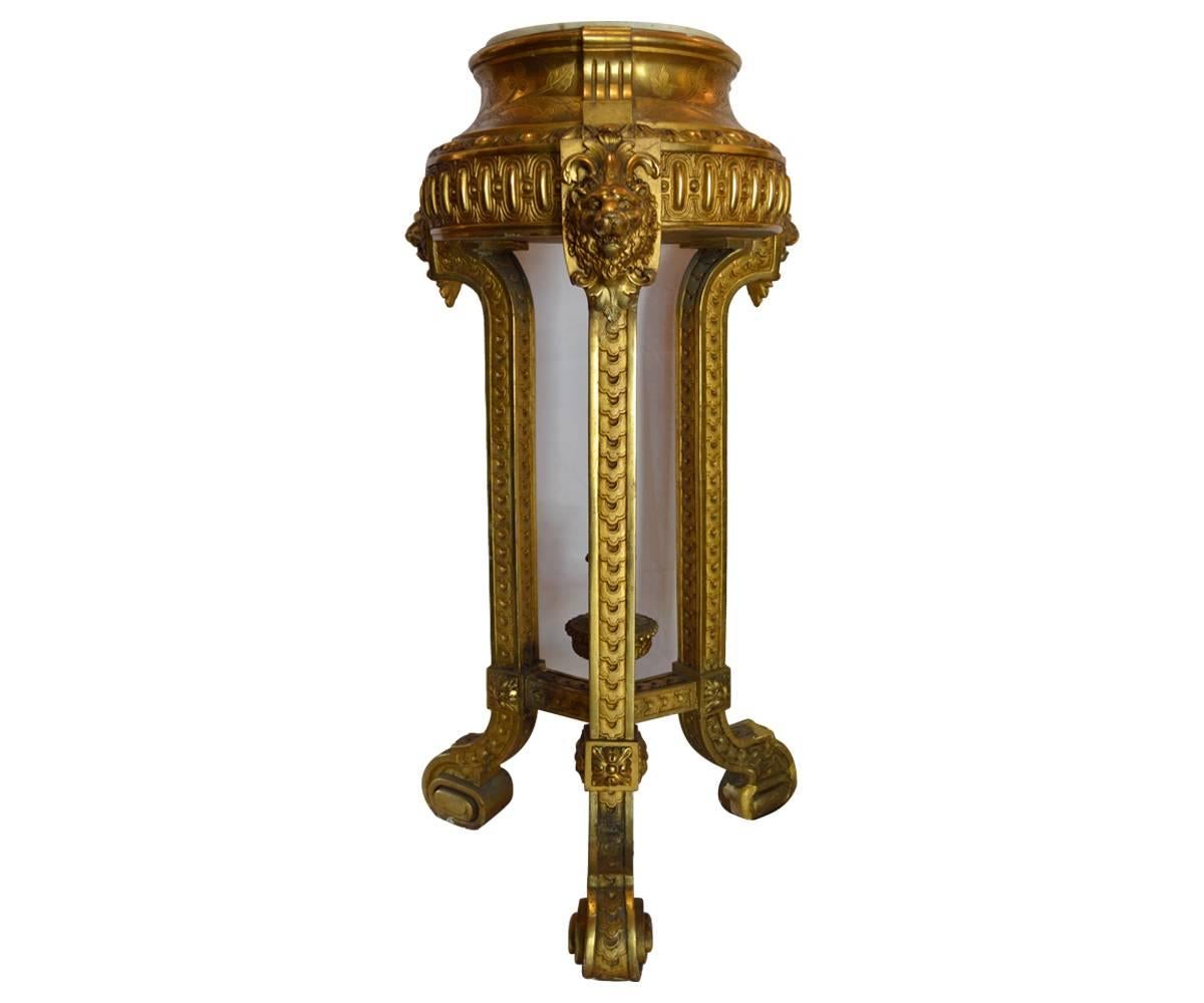 This is simply one of the most outstanding pedestals you will find. The three legged gold gilt pedestal/torchere has intricate carvings throughout featuring the lions faces on the legs which end in a scroll at the feet This pedestal is a piece of