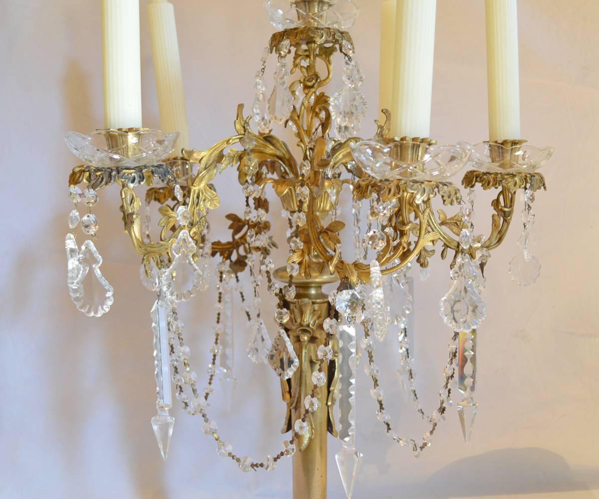 Offered is this pair of antique French gilt bronze candelabra that have had Fine hand cut crystal added for enhanced elegance.

The dimensions are without candles.