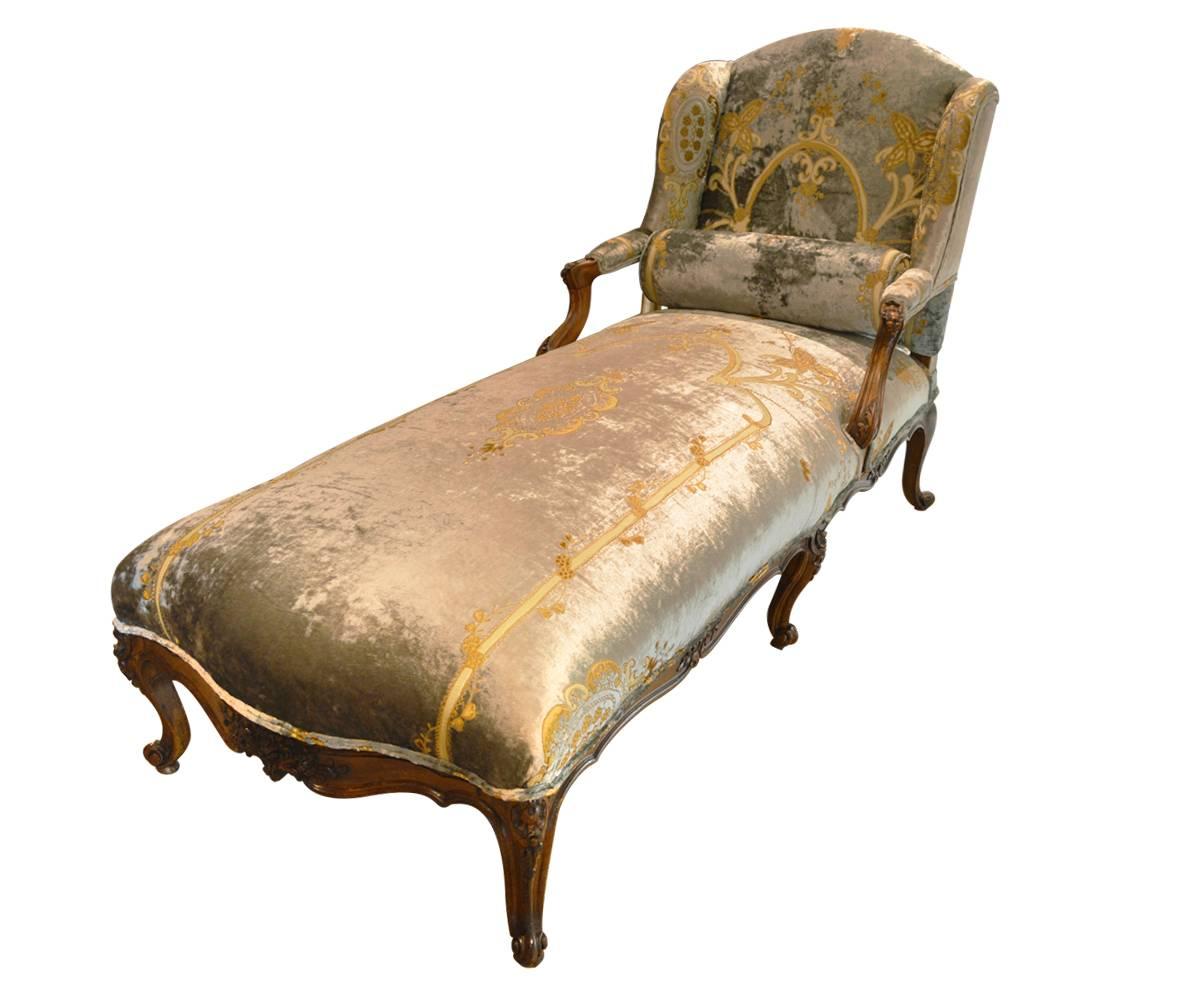 The antique French walnut chaise longue has been completely restored and reupholstered with a fine velvet embroidered pale blue fabric.