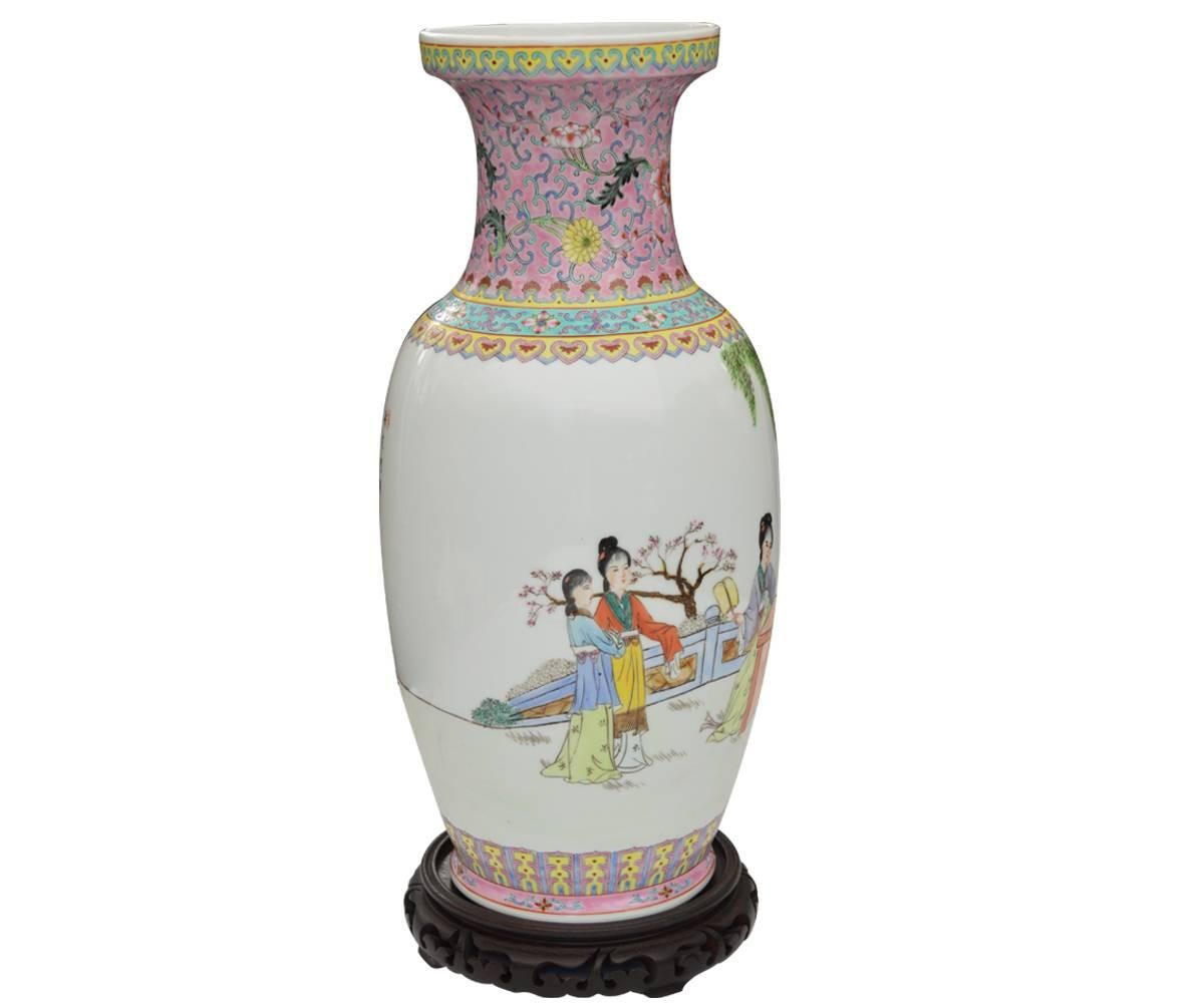 Offered is this pair of Chinese famille rose enameled porcelain vases each of ovoid form and featuring a scene of beauties and floral designs, reserved on a pink ground with an inscription to the body and seal mark to the base.