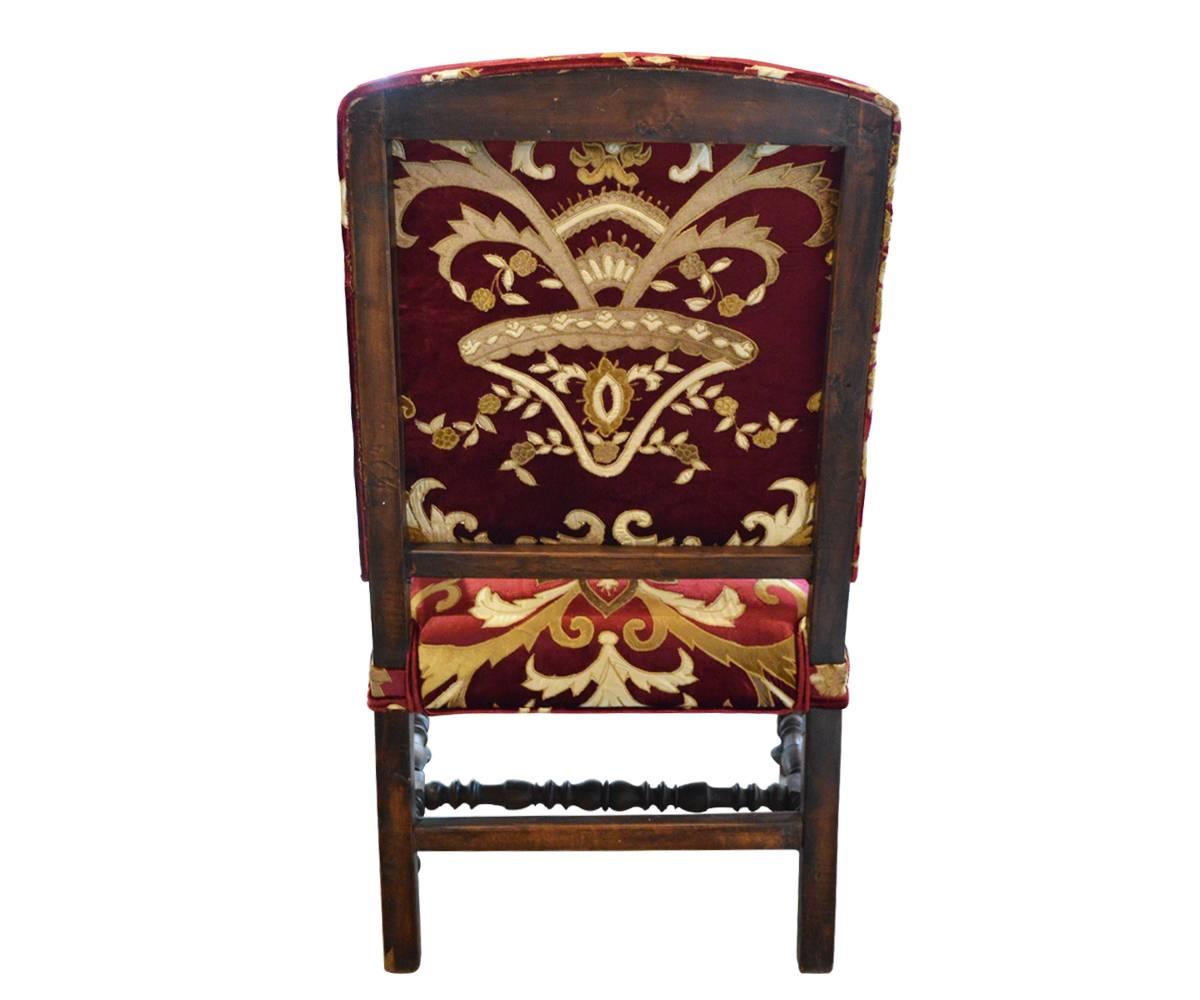 This chair has been professionally restored and reupholstered in an embroidered velvet luxury fabric. It is very comfortable and slightly oversized.