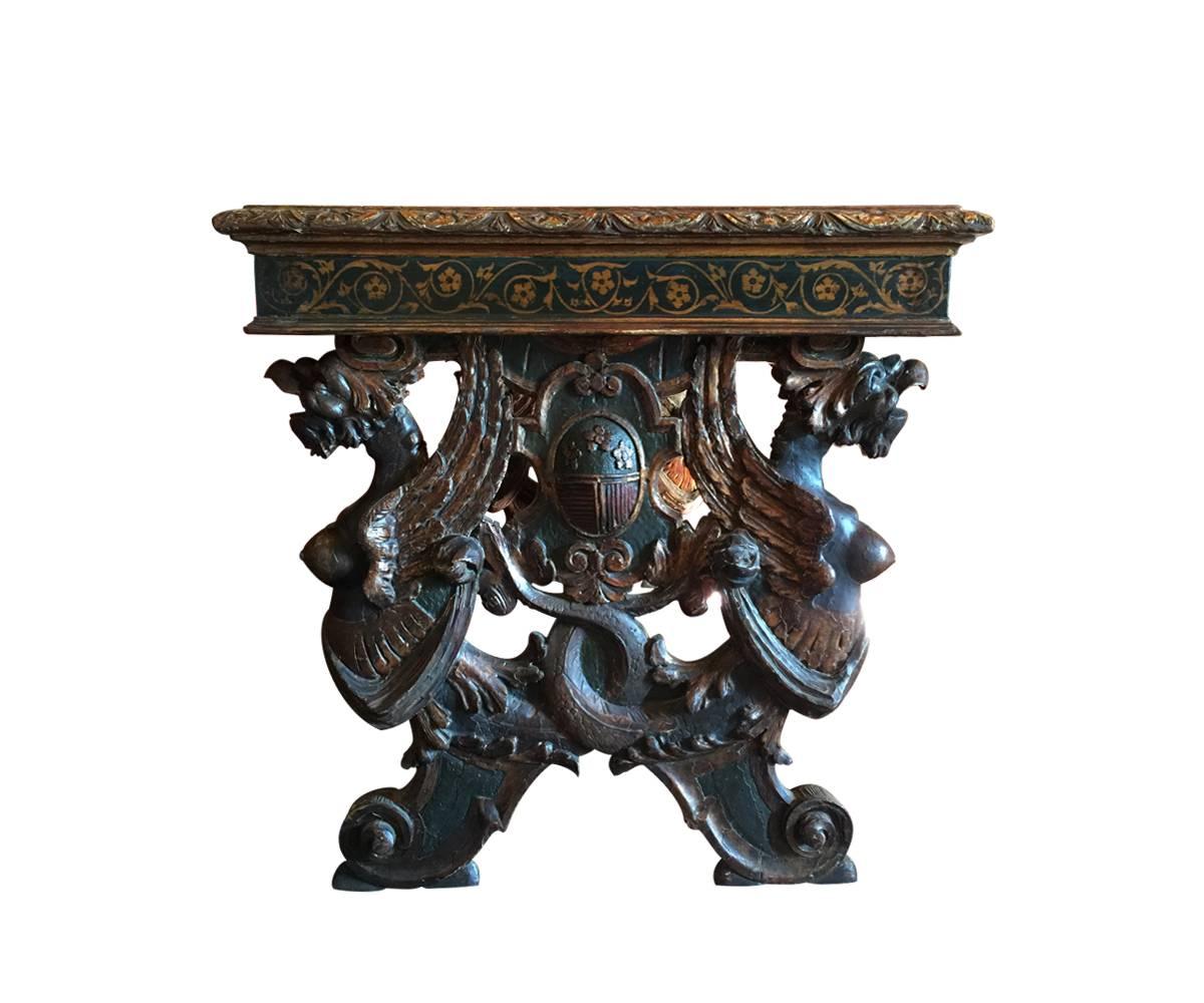 This is a very handsome antique Spanish renaissance style walnut table with the original painting including gold leaf also displayed vibrantly throughout the piece including on the prominent stretcher. The carvings are magnificent and include four