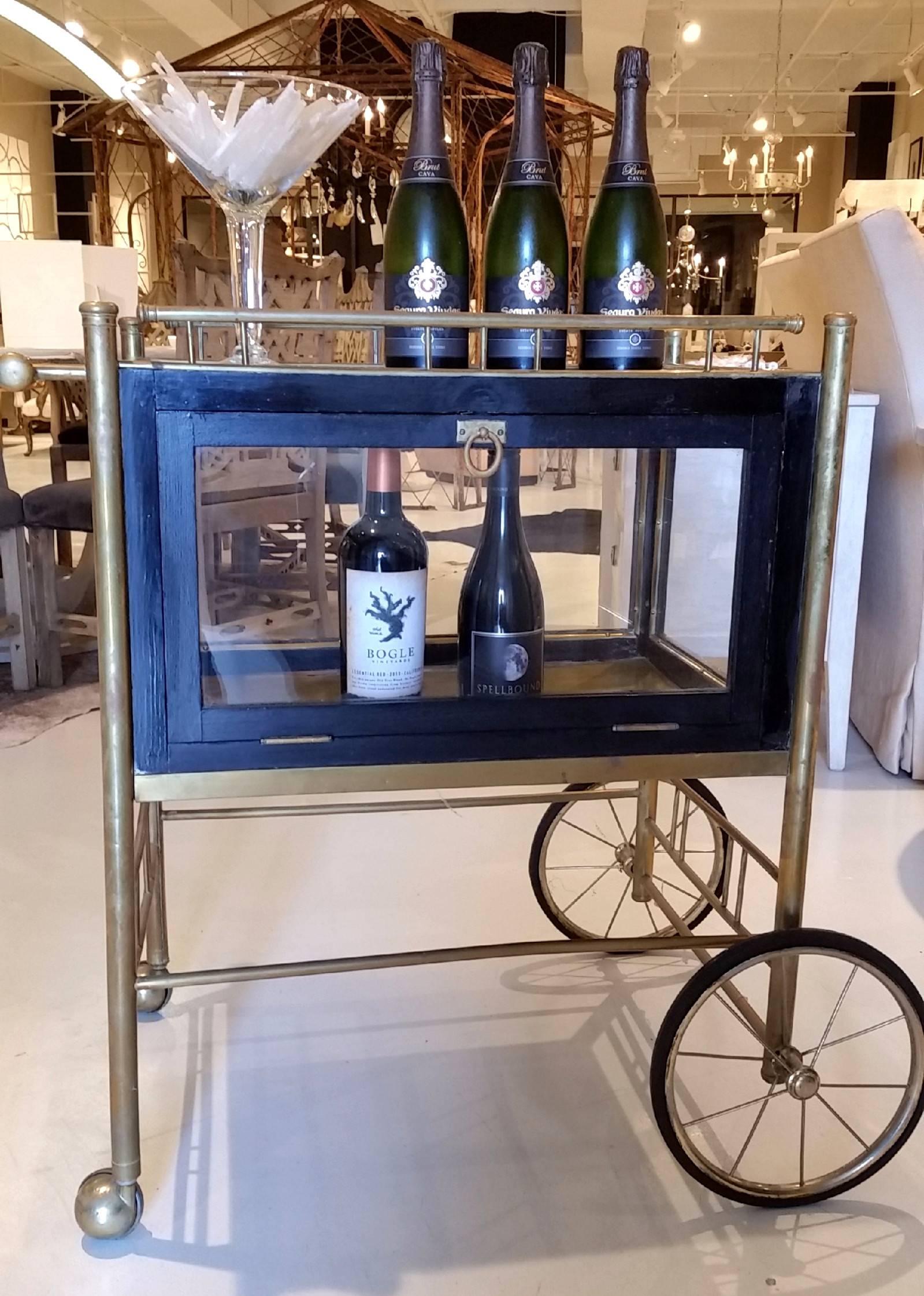 Brass antique bar cart trolley on carriage wheels with accents of wood, Lucite and glass. This is a great piece of vintage furniture for home decor and/or bar accessory. 
Weight 25 lbs.
