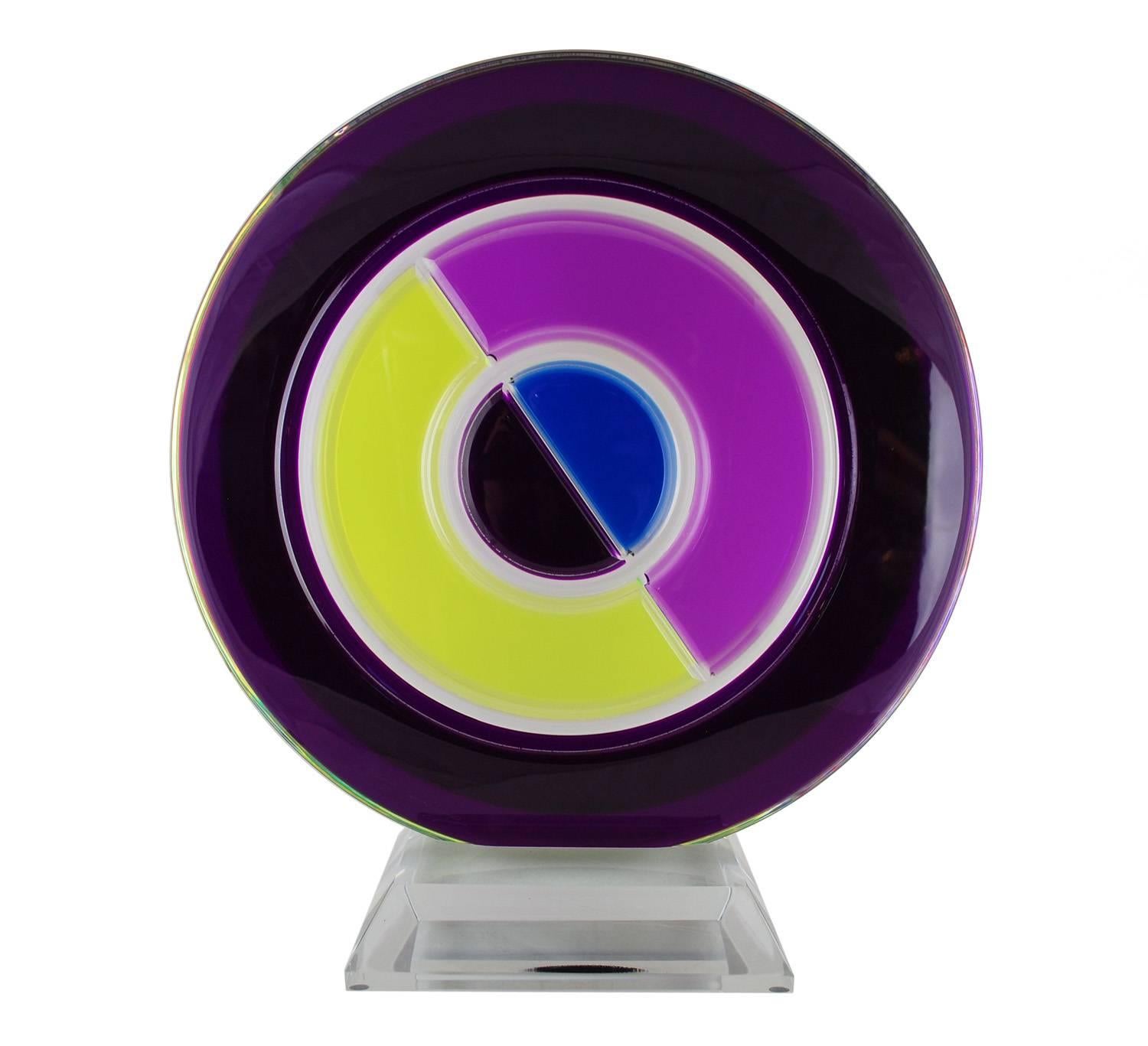 An impactful Lucite art piece by Israeli artist Shlomi Haziza. Crisp, geometric design featuring intense purples, chartreuse and blue on a clear base. 

Great condition, light scratch on the purple top, some on the bottom of the base.

Sophisticated