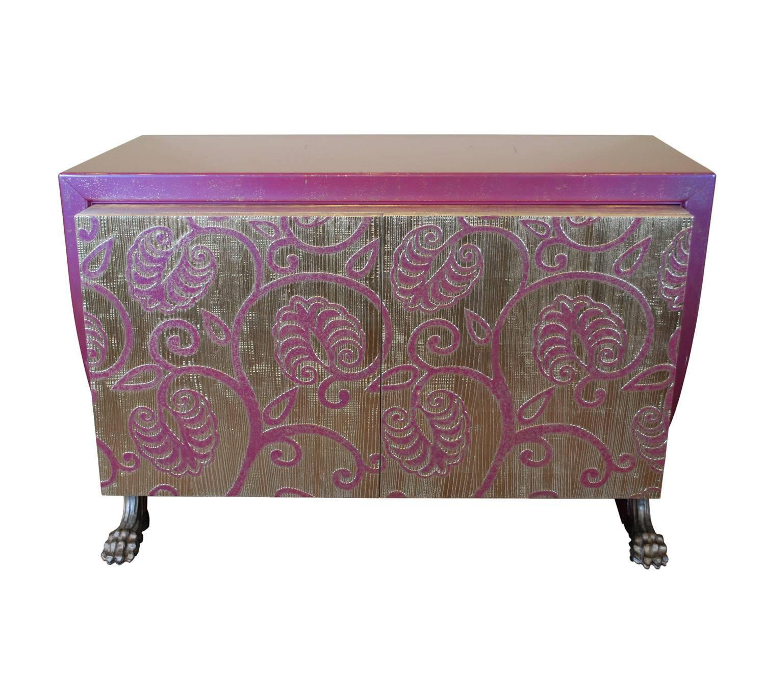 A vibrant large cabinet from Italian designer Carlo Rampazzi.  Glossy  purple finish on sides and the top and silver purple double doors with stylized foliate motif. The cabinet perches on silver claw feet. 

The interior is divided into two
