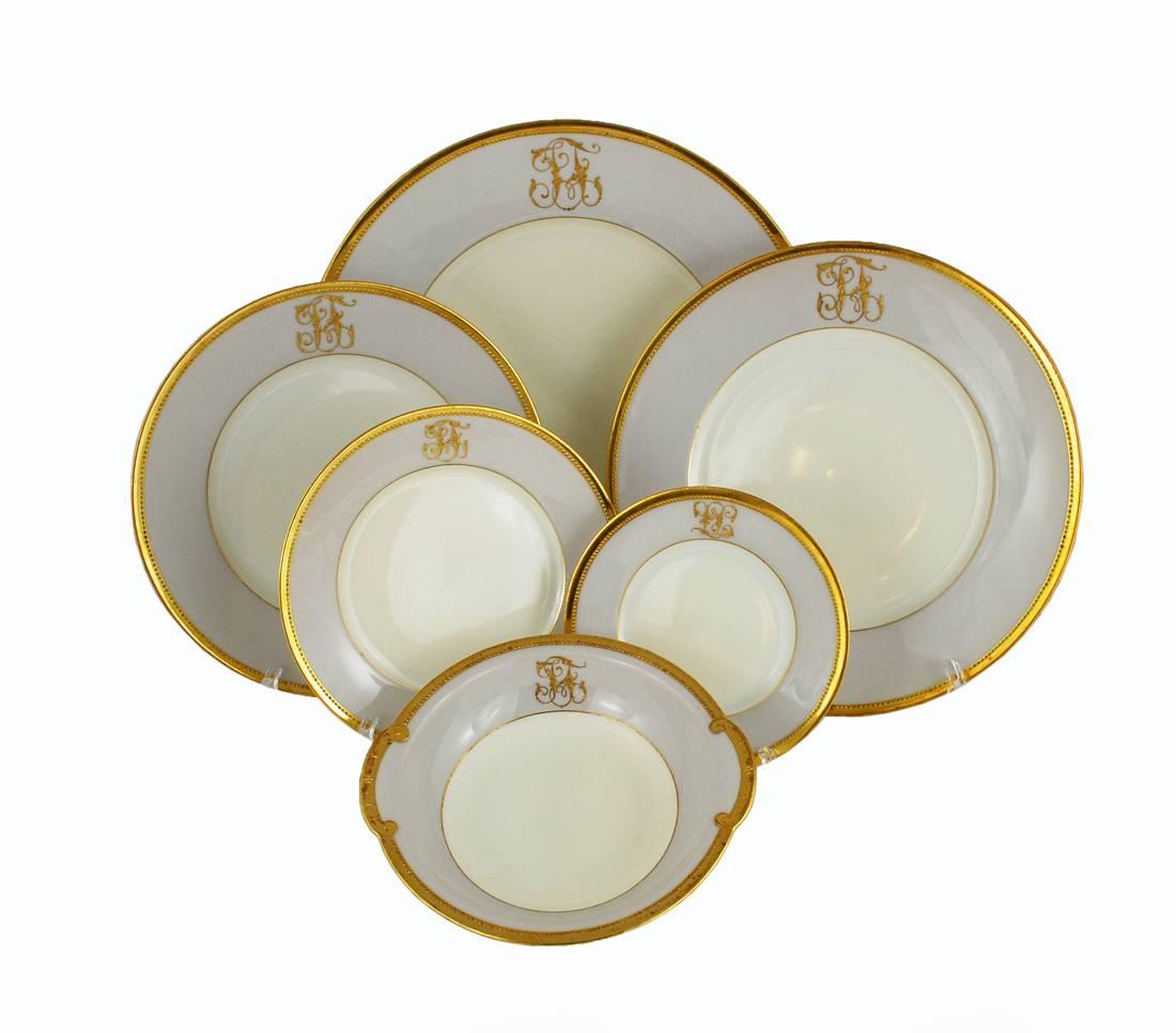 Elegant Art Deco dinner service for eight from the highly prized Dresden Ambrosius Lamm Studio. This large set displays sophisticated simplicity with tastefully restrained adornment. A ground color of light cream is surrounded by a rim of pale