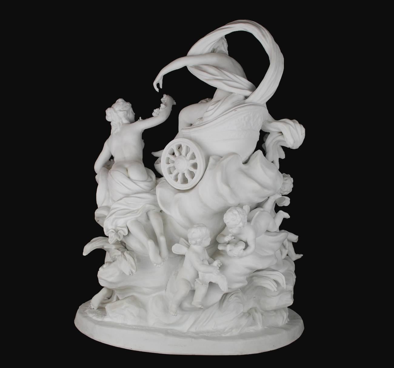 This rare 19th century white parian sculpture in the round features the goddess being attended by maidens and cherubs. From the base up, every living creature is in mid-action, creating visual movement that draws the eye upwards toward the pinnacle: