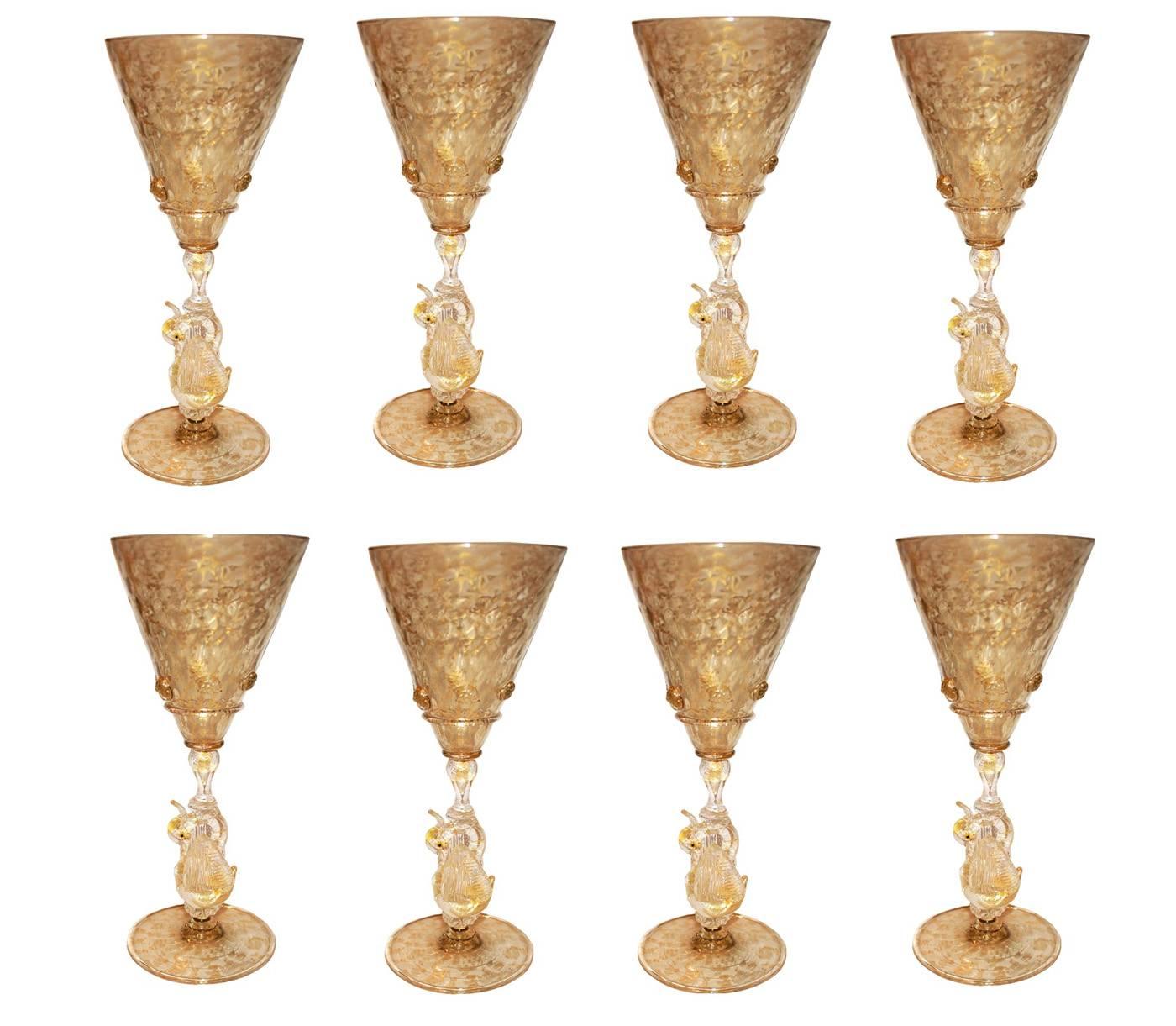 An amazing set of hand blown Venetian glass wine or water goblets. This set of eight features elegant swan stems and copious gold flakes throughout. The base and conical cup have a subtle ripple pattern. The cup is embellished with textured glass