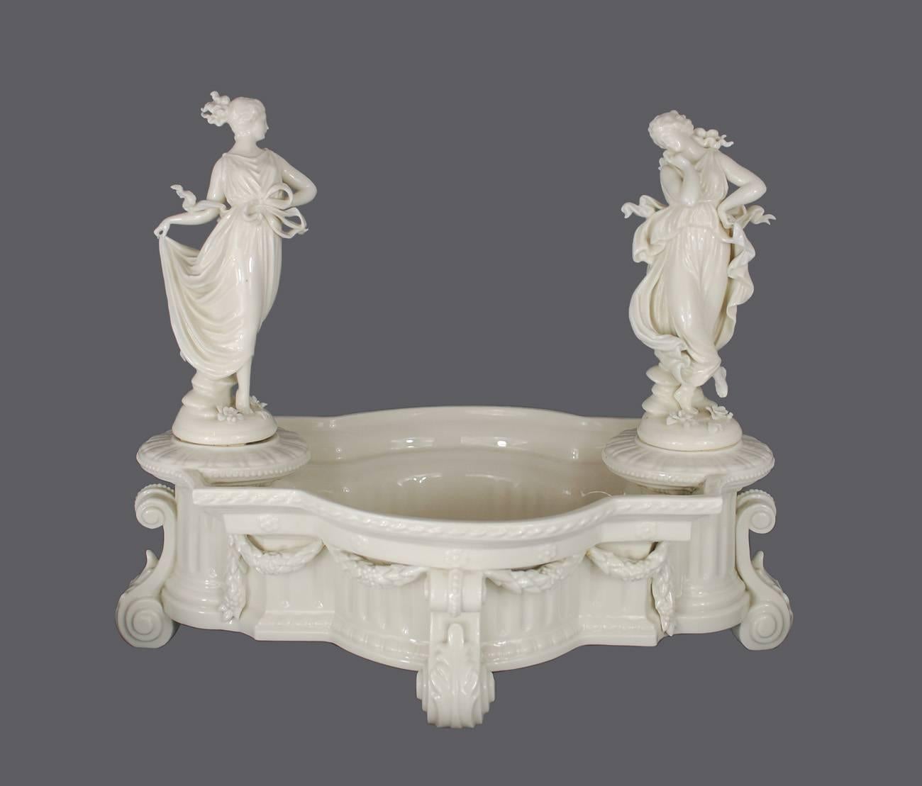 Amazing the 19th century porcelain centerpiece set featuring a bowl and seven dancing maiden figurines by Capodimonte. The bowl is fashioned in a column motif complete with swags and garlands. Would be perfect for flowers, candies, or fruits. Atop
