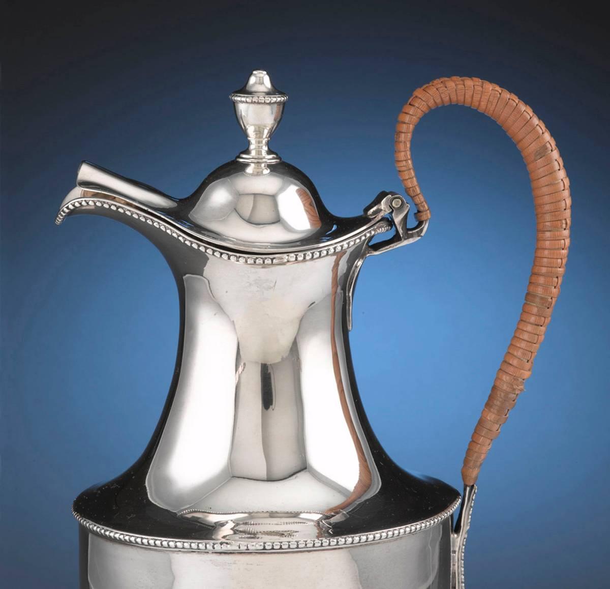 Elegant sterling silver jug by famous silversmith Hester Bateman. Simplicity and elegance of form are complimented by the slightest detail of beaded edges. Insulated wicker wrapped handle prevents heat transfer and adds an organic contrast to the