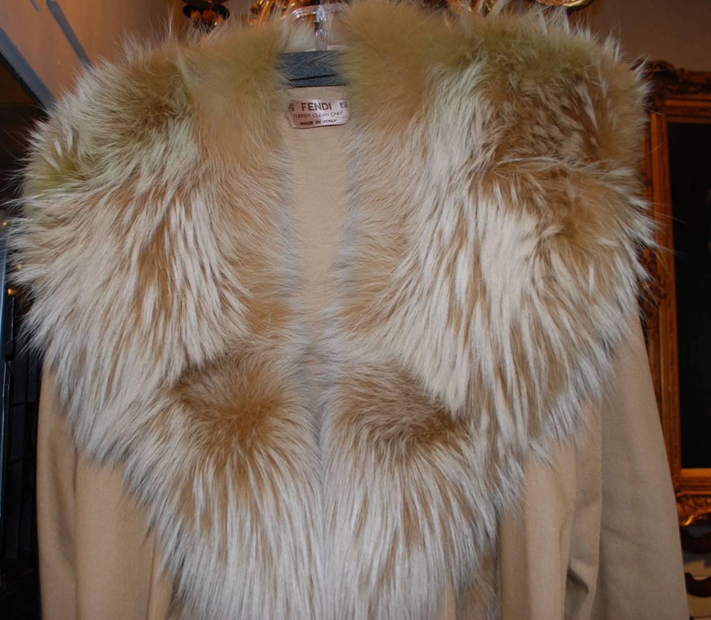 This is an amazing vintage Fendi Runway coat with high quality tan color fox collar and trim. The finely woven fabric is wool, lining is quilted jersey, sleeves are not lined. 
Fox fur makes up the wide collar and the trim continues down the right