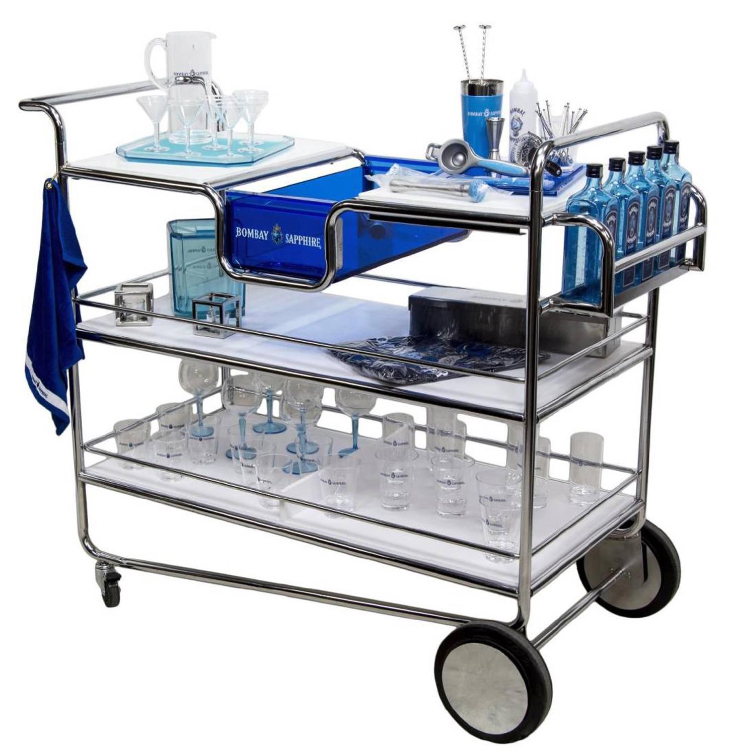 A stylish large bar cart set from famous liquor maker Bombay Sapphire. 

This is one of a kind bright piece that was made for advertising purposes .
The tubular chrome frame supports three levels of shelving. In the middle of the top shelf is a