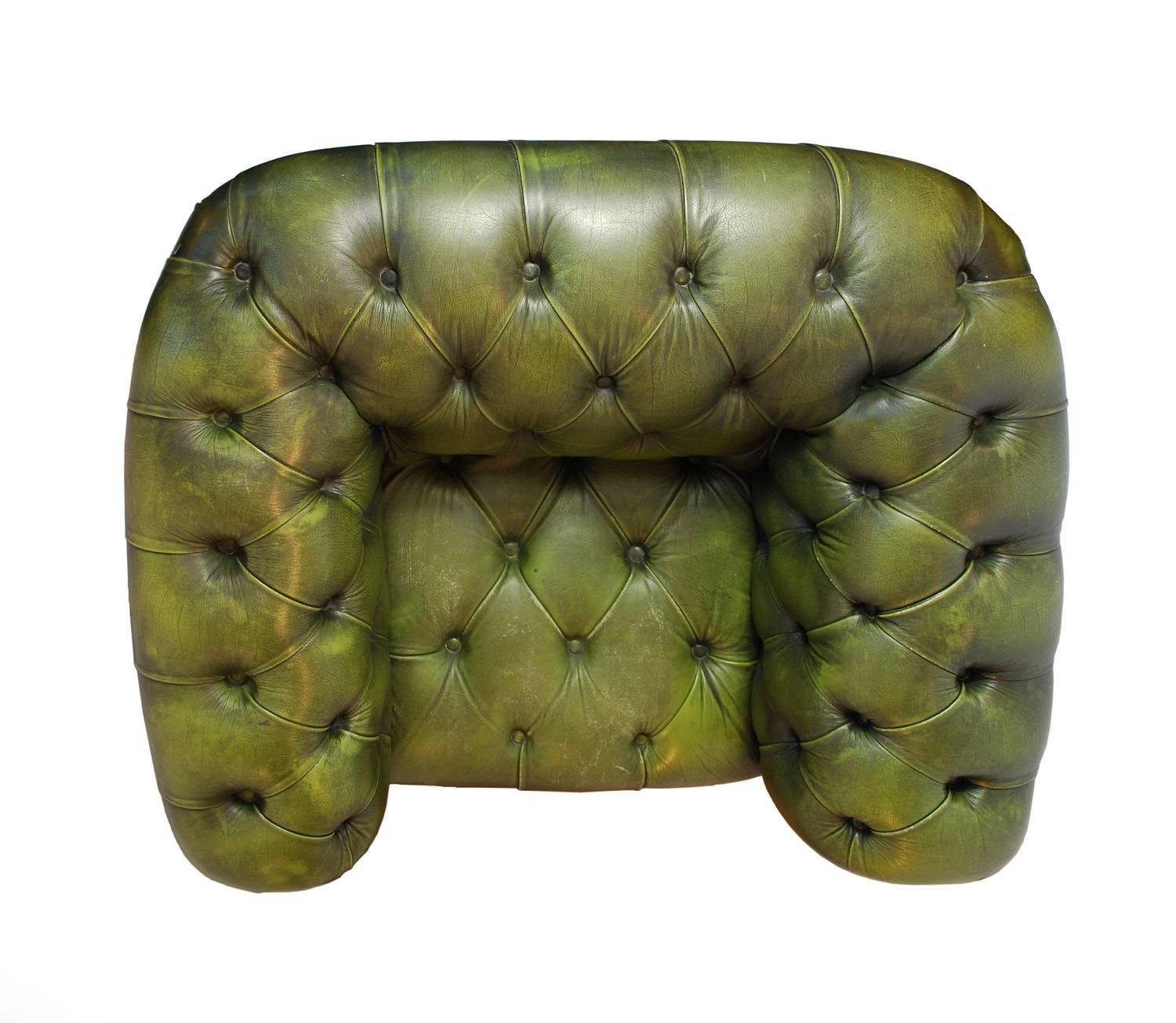 A very handsome Chesterfield tufted leather club chair in distressed deep green. Classic features include nailhead trim and bun feet. Well proportioned and very comfortable.

Generally good vintage condition, substantial wear on the leather