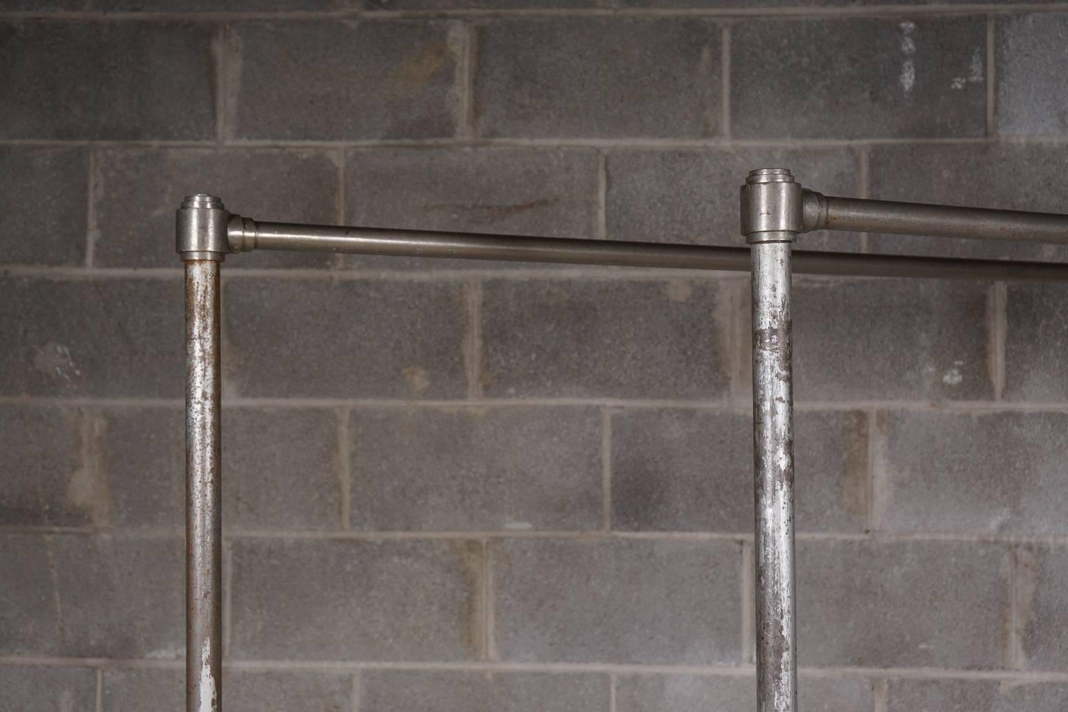 Pair of metal clothing racks from France. Running casters.