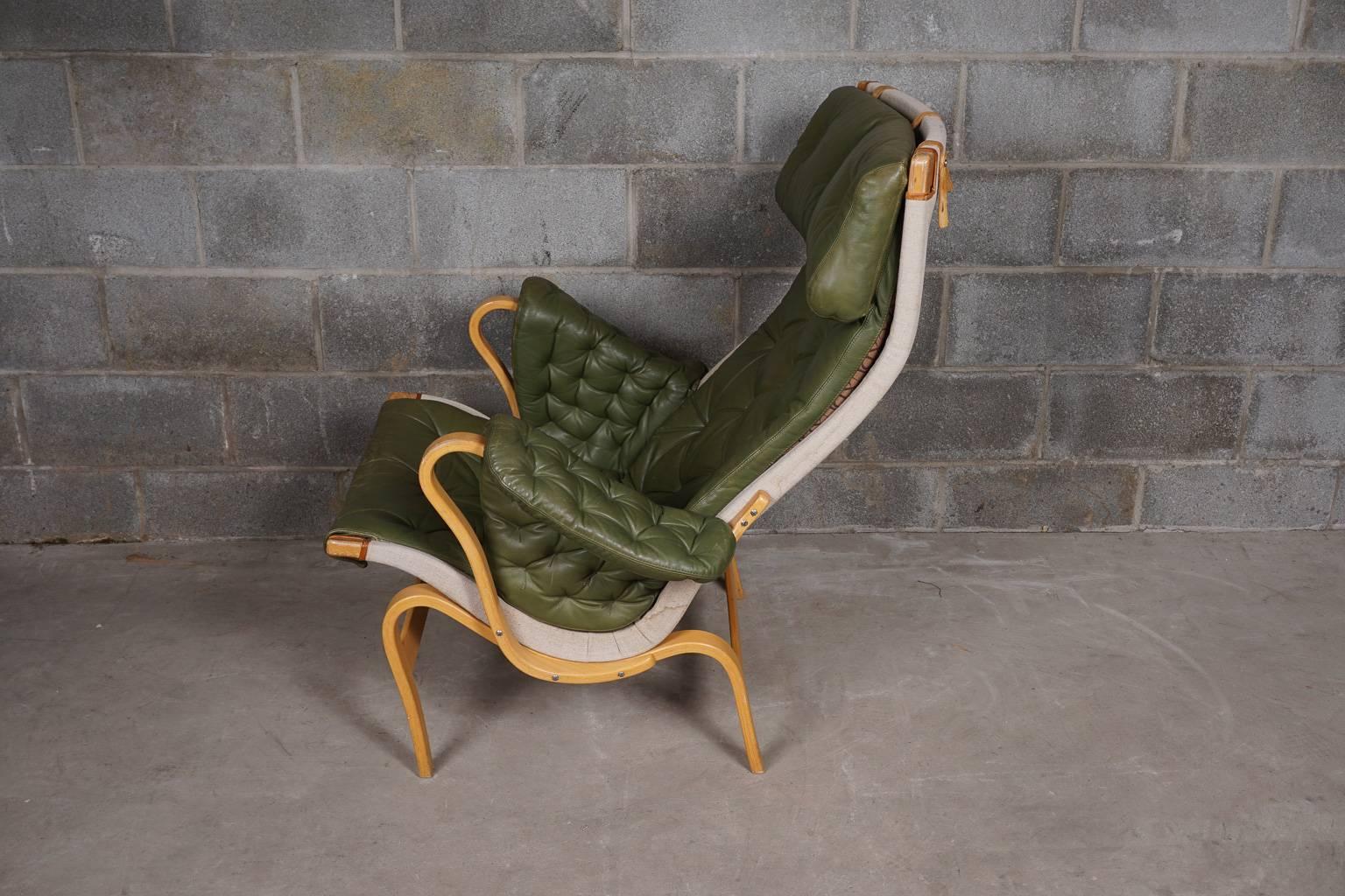 Bruno Mathsson lounge chair, model Pernilla. Rare, original green tufted leather on a birch frame. Nice patina to leather.