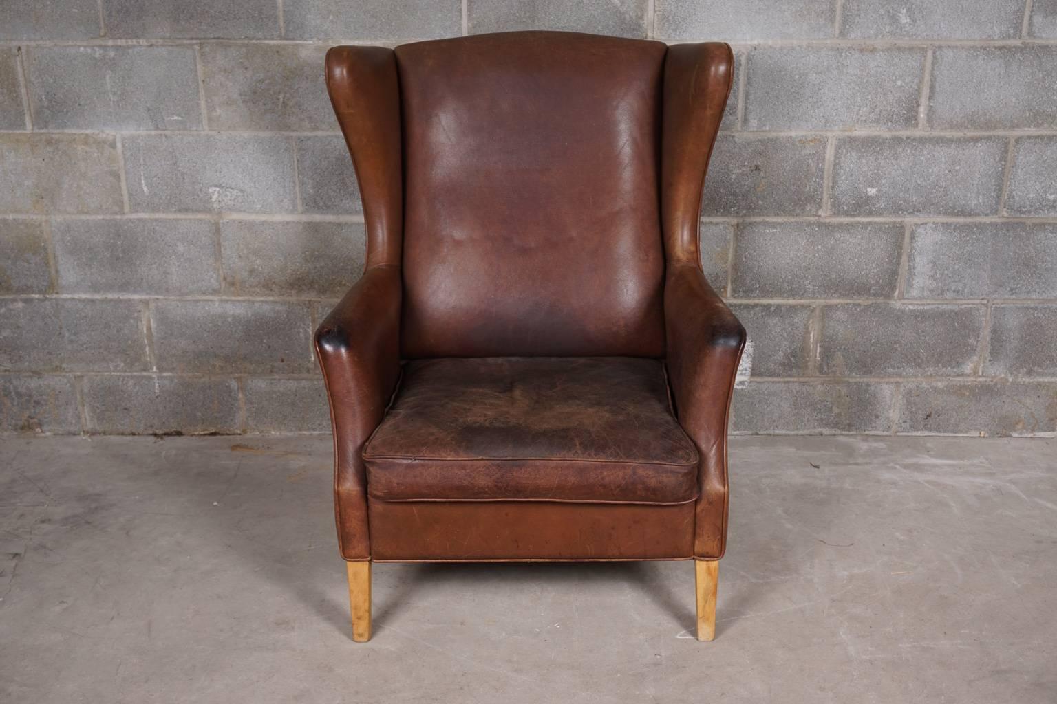 Danish brown leather wingback chair. Great patina and wear.